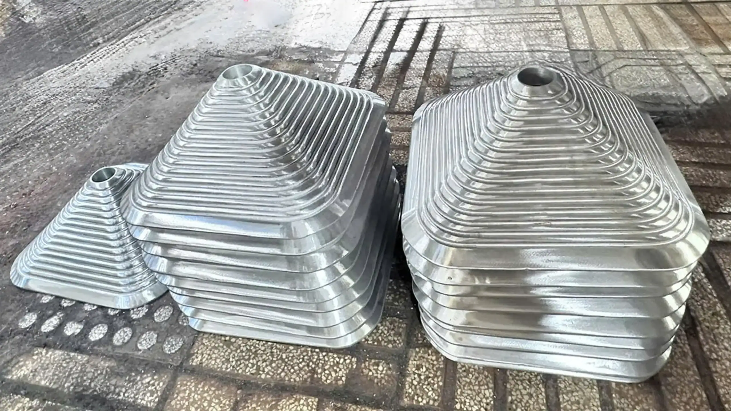 Stacked conical metal components used for table bases or detailing, demonstrating precision metal stamping and shaping capability.