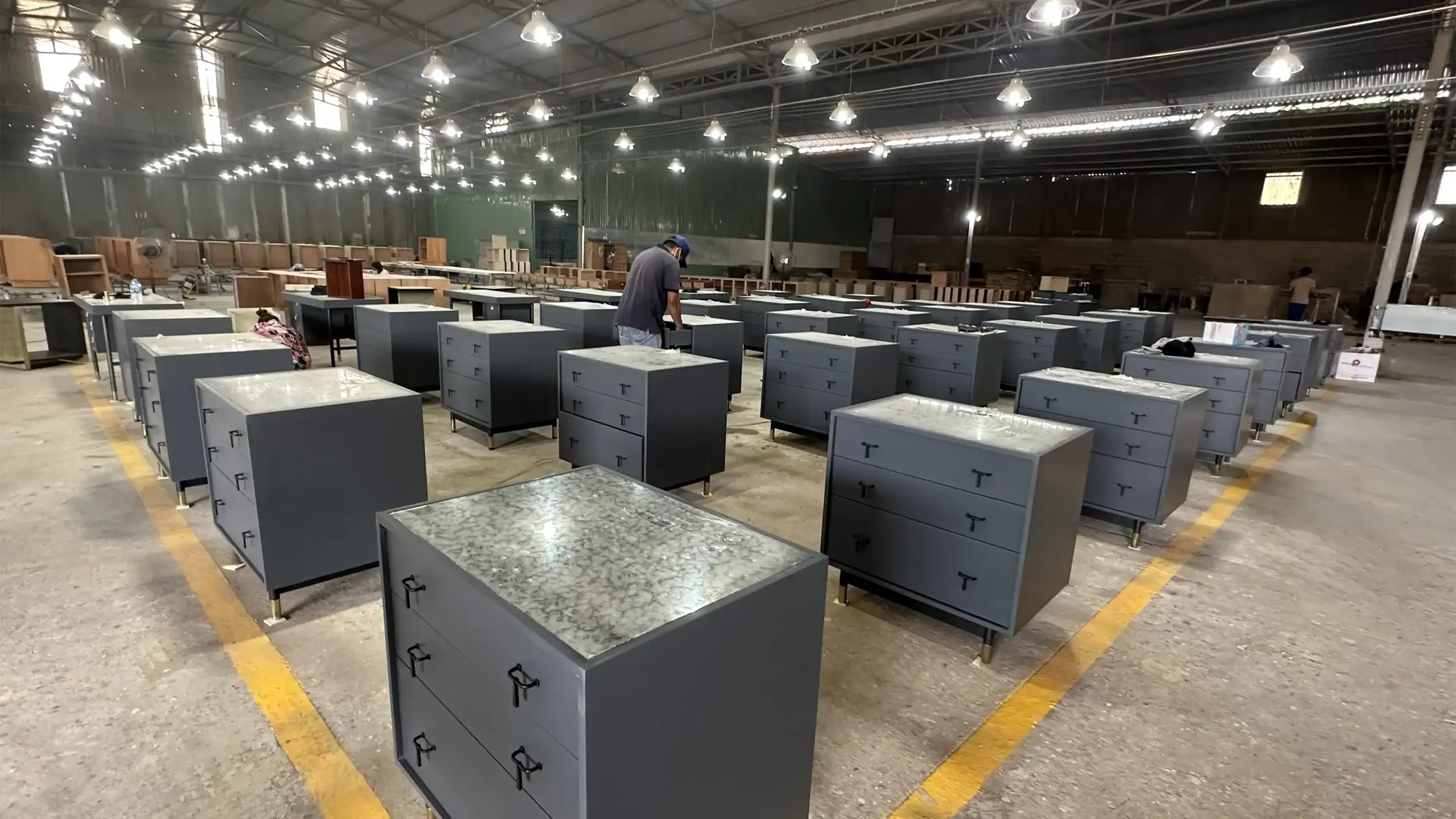 Hotel dressers and casegoods with powder coated metal handles and base, featuring a stone-look composite top.