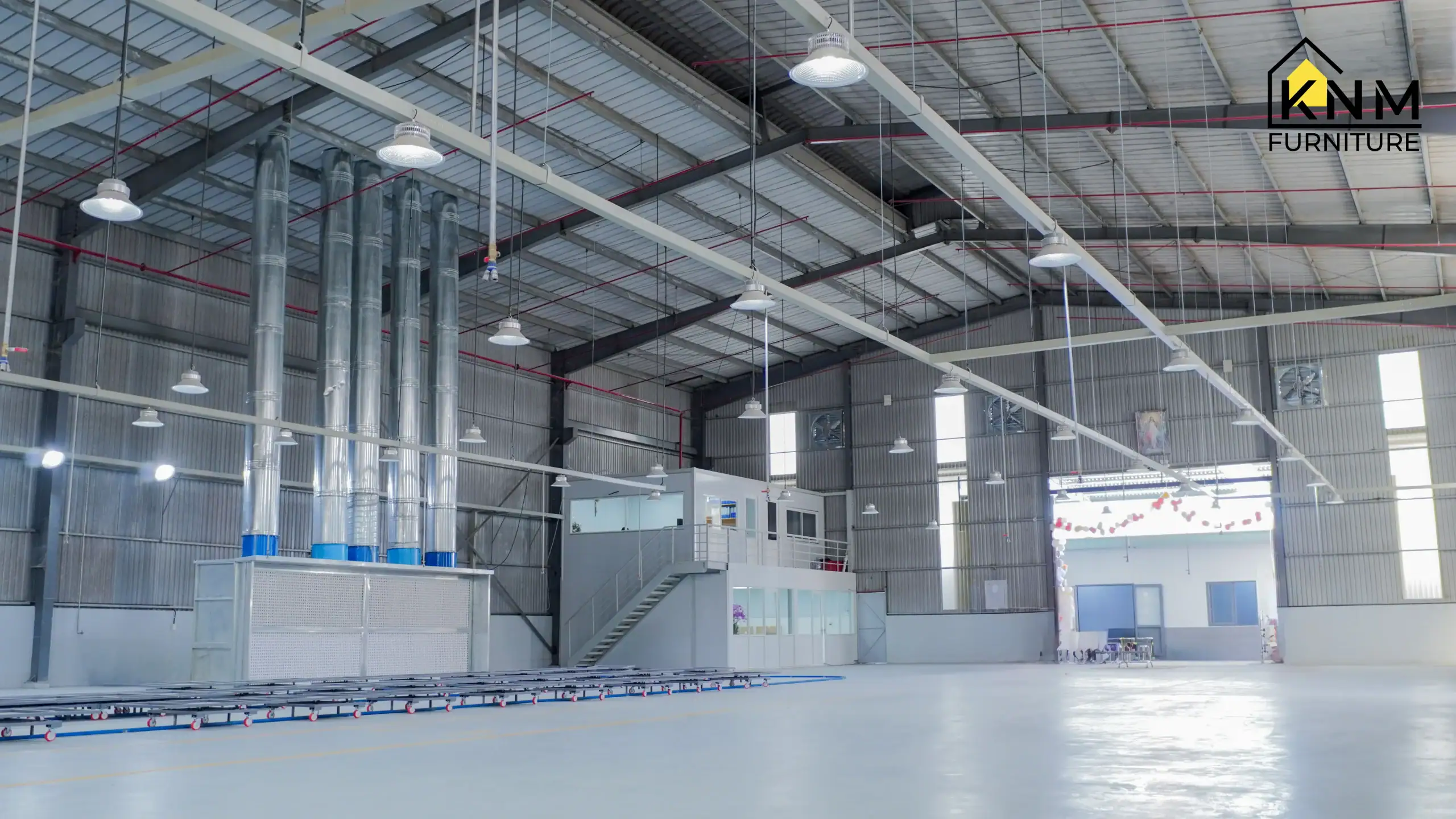 Wide view of the large-scale Khanom Furniture Vietnam industrial factory floor, showcasing the integrated QC office structure and advanced surface treatment area for high-volume hospitality furniture manufacturing.