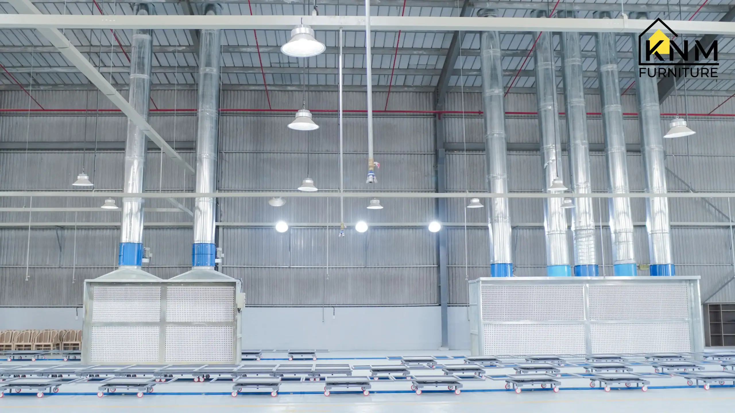 Wide view of the main Khanom Furniture production line in Vietnam, showcasing technical infrastructure, centralized piping, and machinery supporting efficient mass production of hospitality furniture components.