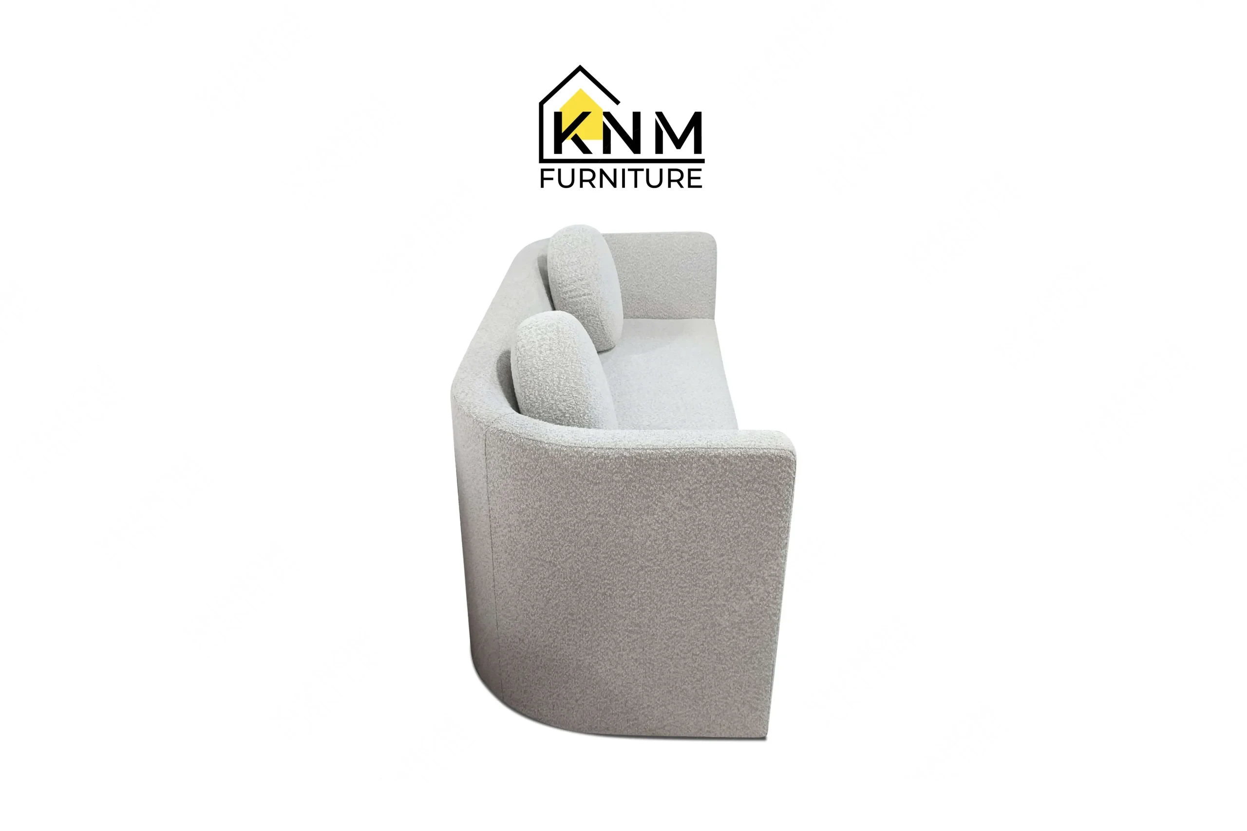 Side profile view of a sturdy contract-grade suite daybed featuring grey textured boucle fabric, produced by Khanom Furniture (KNM Furniture), a dedicated bespoke furniture factory.