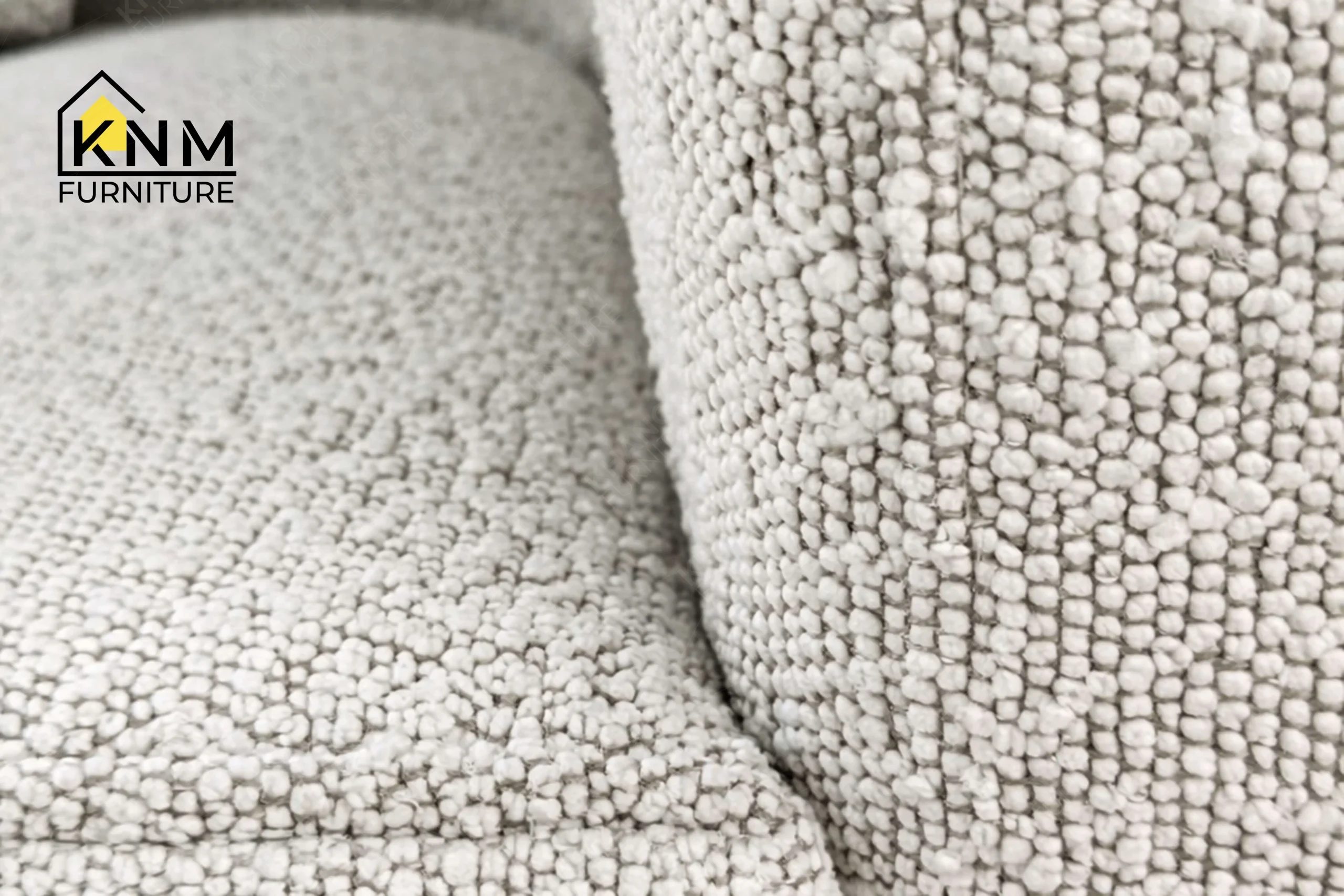 Detailed view of the rich textured grey boucle surface on a premium hospitality daybed, crafted by Khanom Furniture (KNM Furniture), a premier hospitality furniture manufacturer.