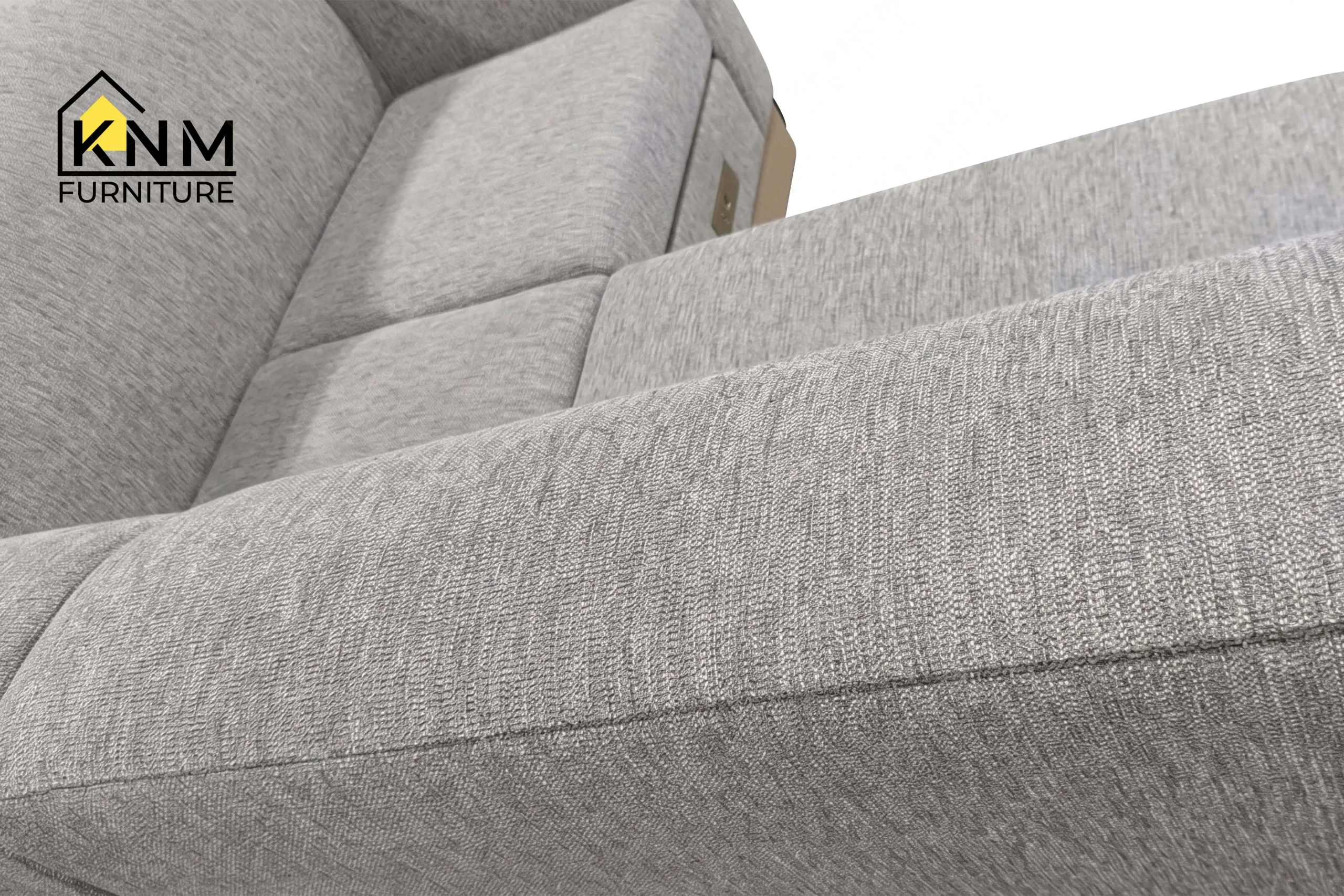 Detailed view of the rich textured grey fabric surface on a premium hospitality sectional sofa, crafted by Khanom Furniture (KNM Furniture), a premier hospitality furniture manufacturer.