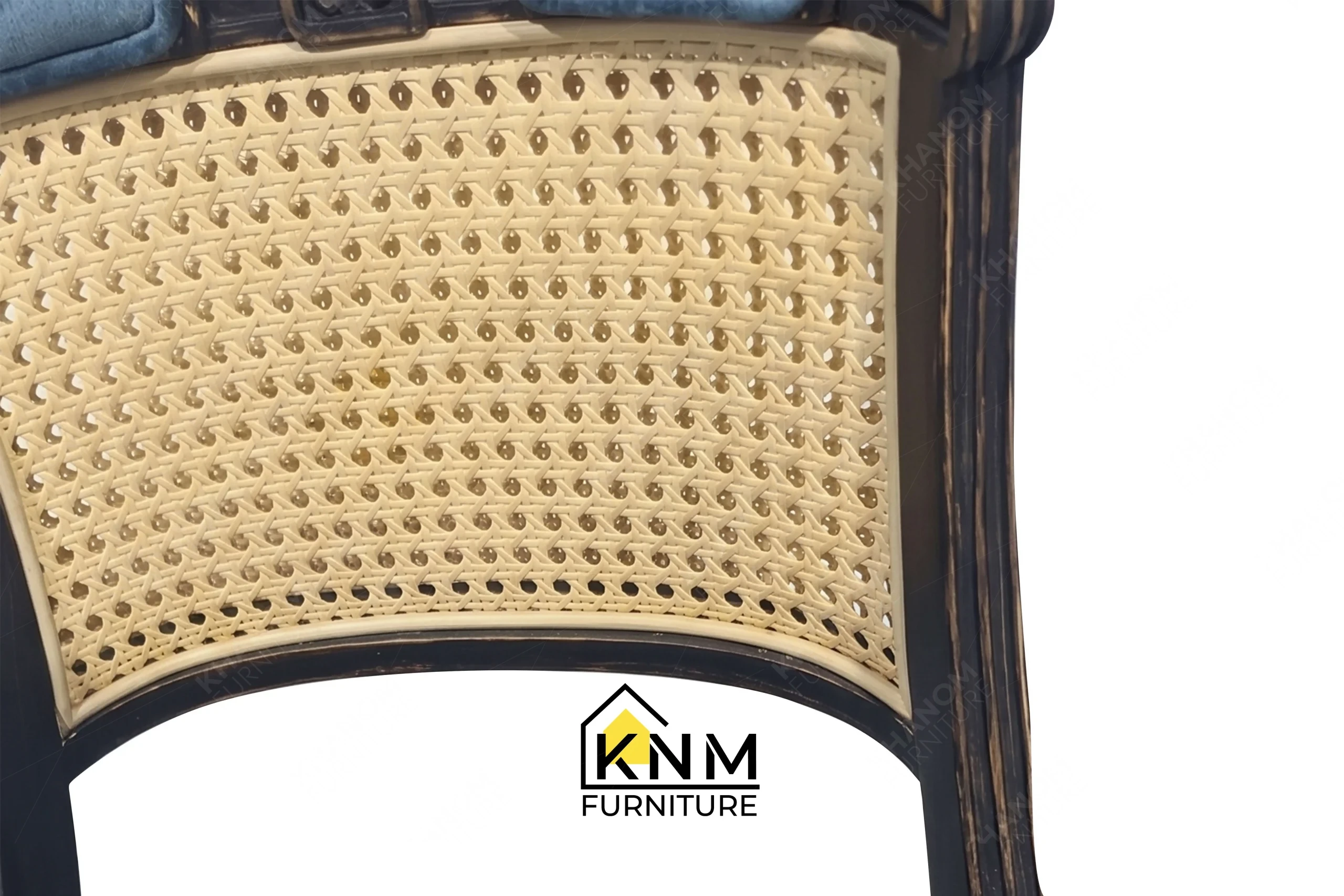 Zoom detail showcasing the premium material integration of a bespoke rattan and oak dining chair, meticulously manufactured by Khanom Furniture (KNM Furniture), your reliable custom furniture manufacturer Vietnam.
