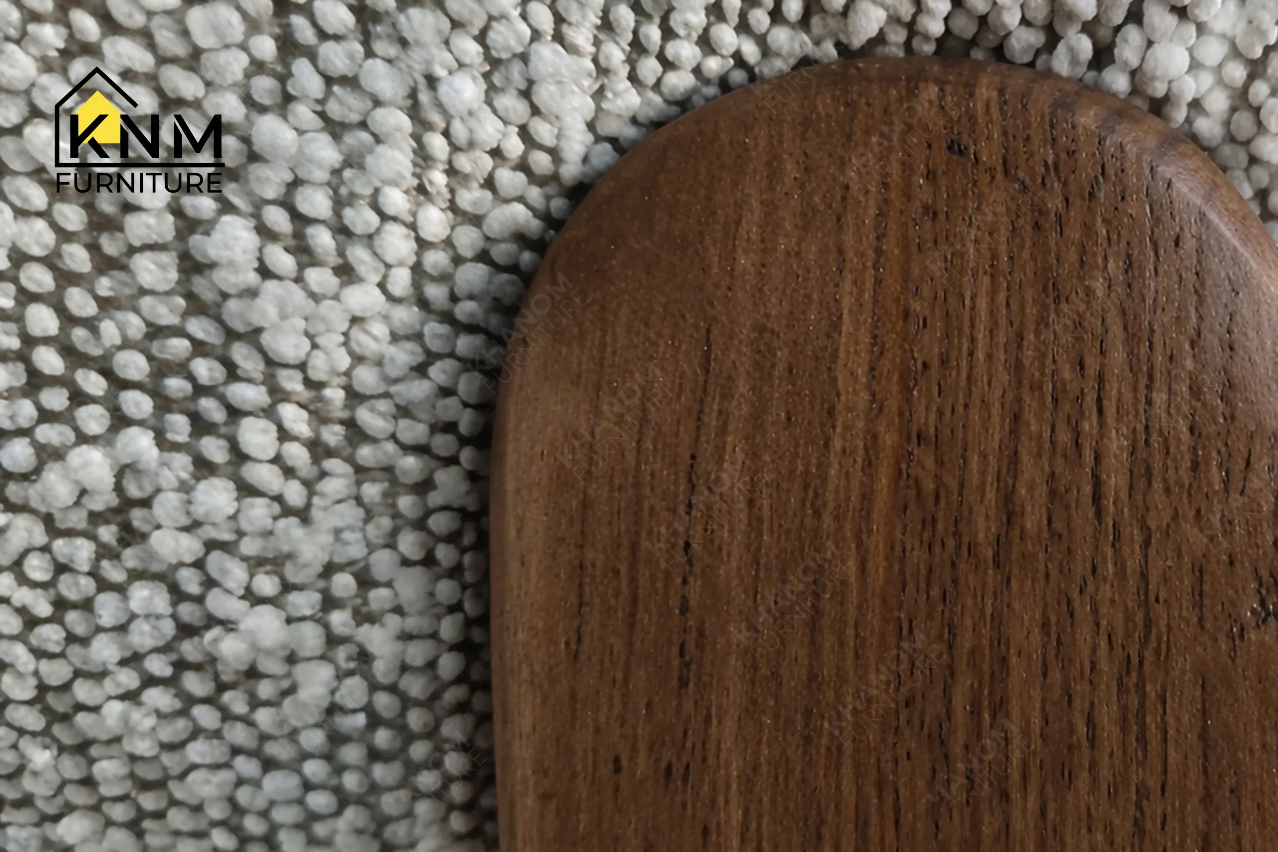 Close-up detail highlighting the refined craftsmanship and flawless finish of a custom upholstered oak chair manufactured by Khanom Furniture (KNM Furniture), an established contract furniture manufacturer Vietnam.