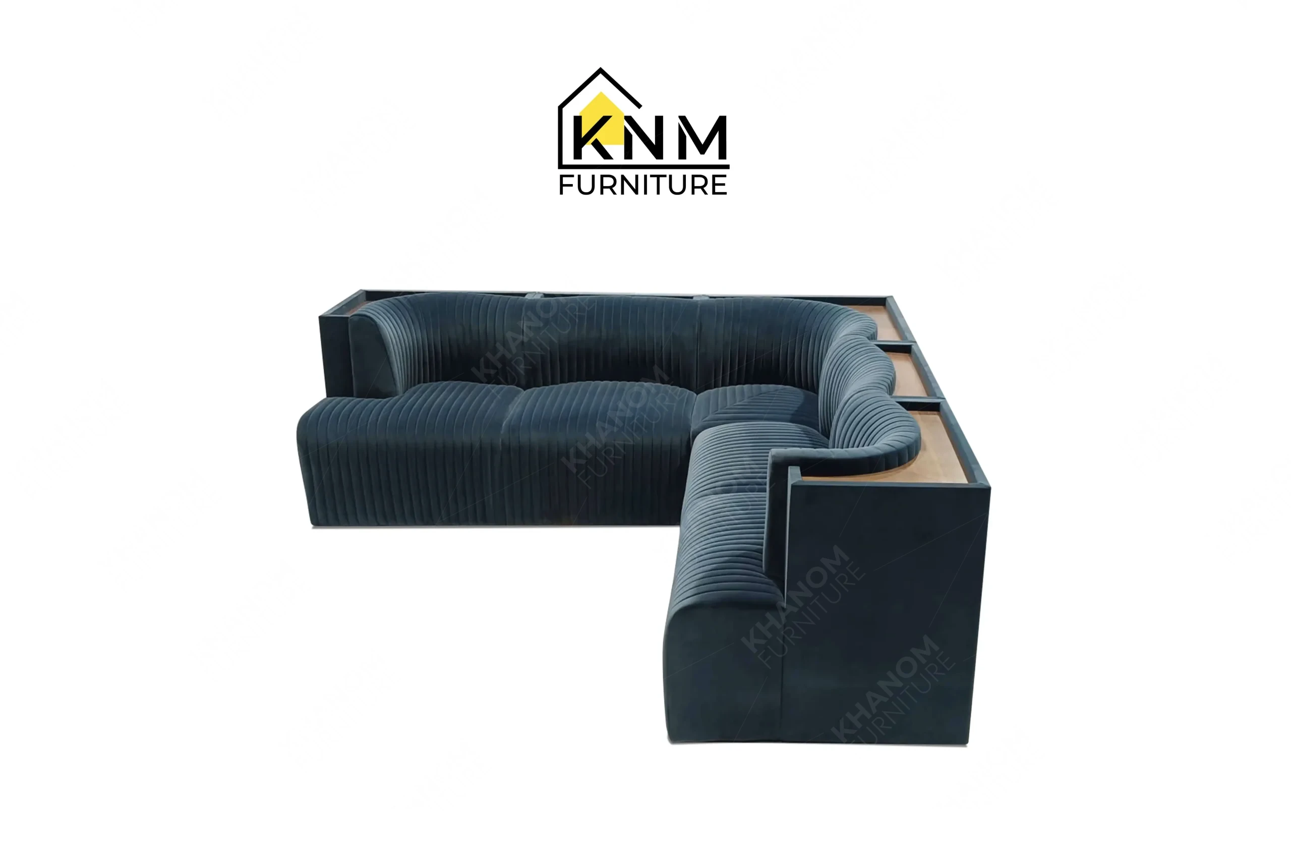 This front view displays the blue velvet channel tufted sectional manufactured by Khanom Furniture, highlighting the vertical upholstery stitching and internal solid wood framing.