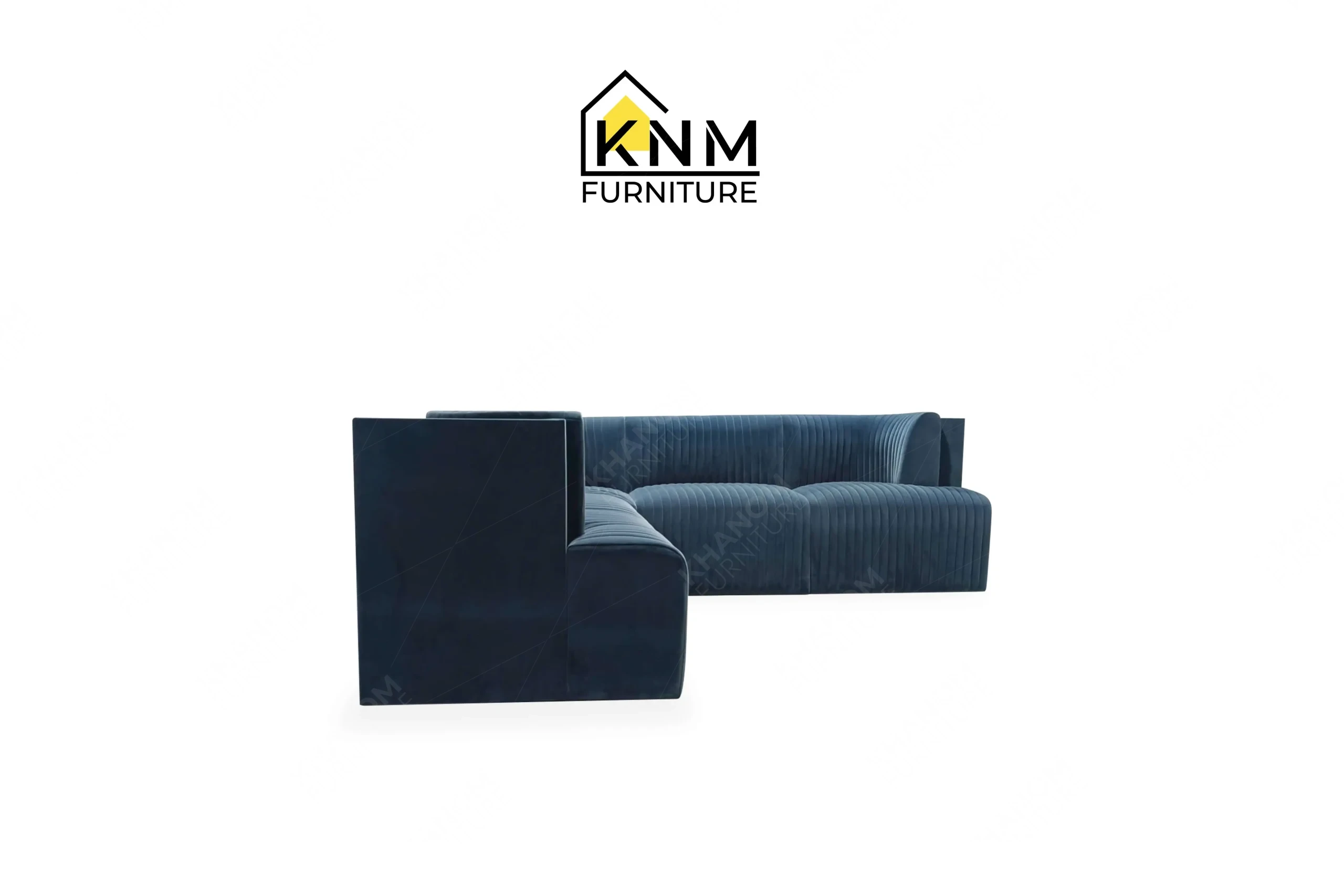 The side profile of the blue velvet channel tufted sectional highlights the structural integration of the walnut veneer back panel specified by Khanom Furniture.