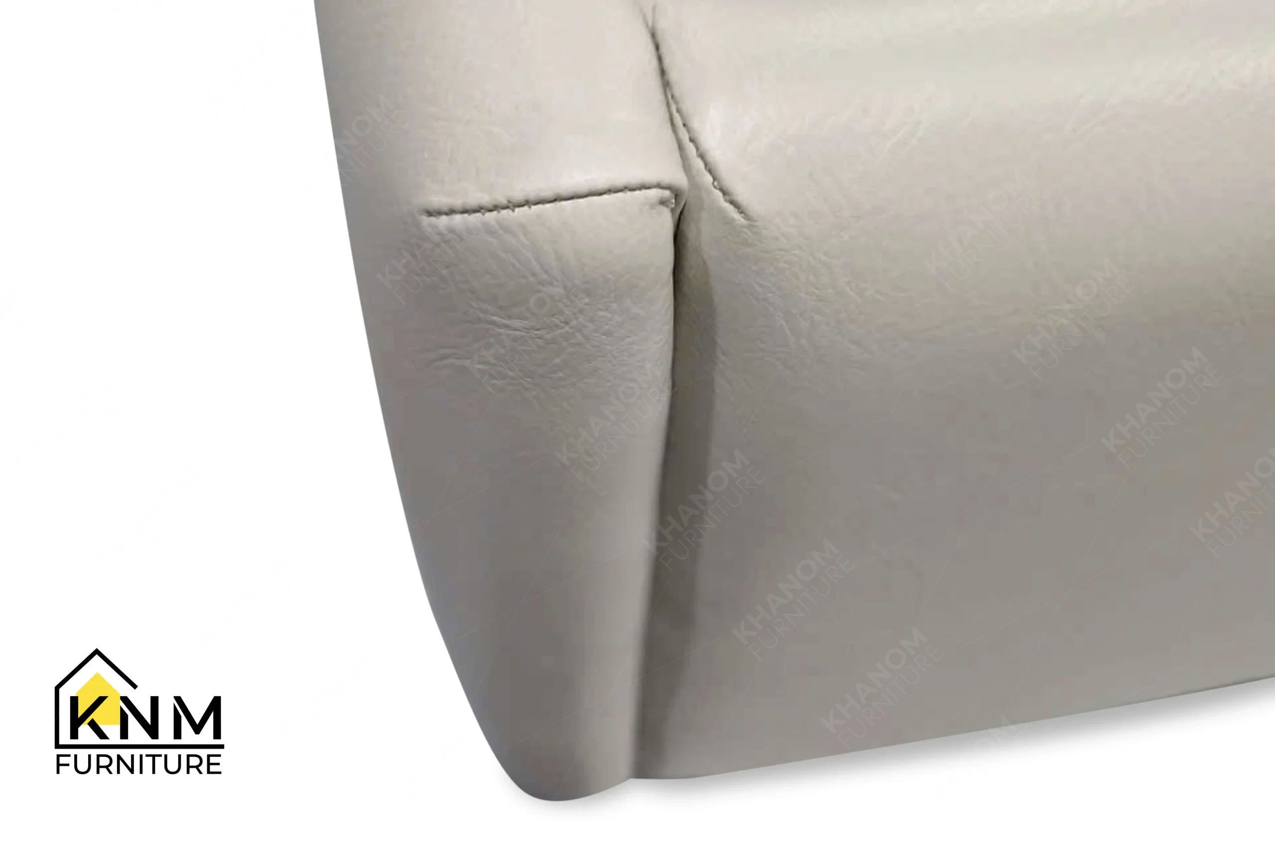 The surface texture detail of the bronze Granex upholstered bed system manufactured by Khanom Furniture reveals the concealed LED lighting integration.