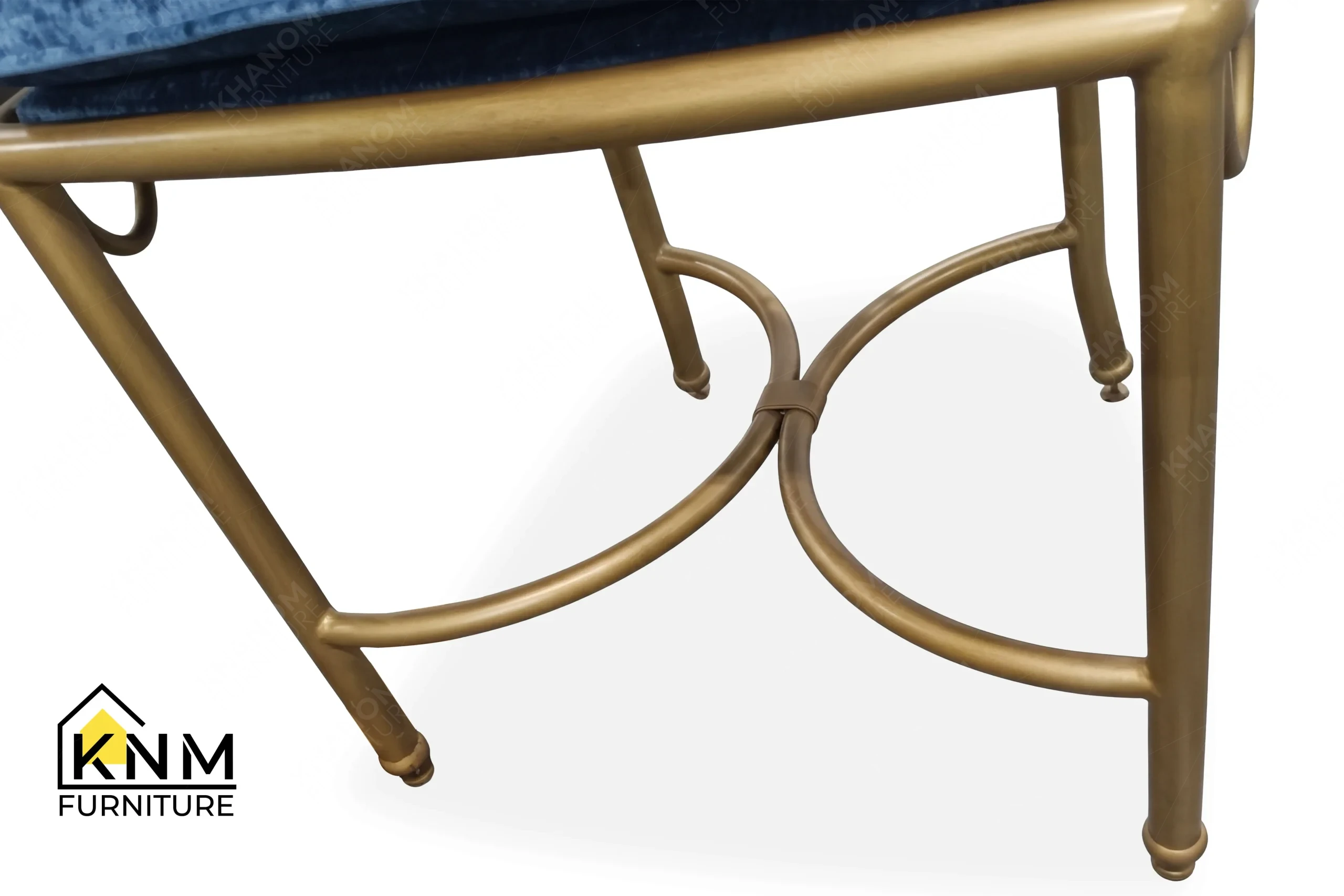 The surface texture detail of the scalloped brass outdoor dining chair manufactured by Khanom Furniture reveals the protective UV-resistant powder coating.