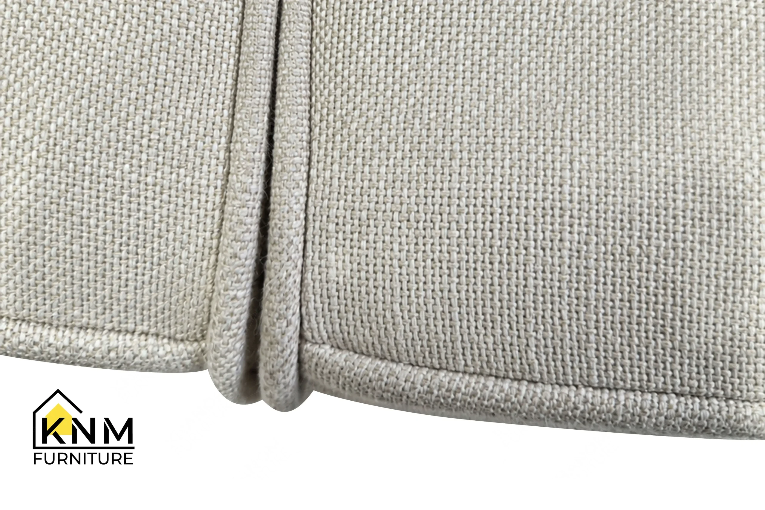 A detailed material zoom of the solid teak outdoor sectional sofa by Khanom Furniture, showing the performance fabric texture adjacent to the light stained teak.