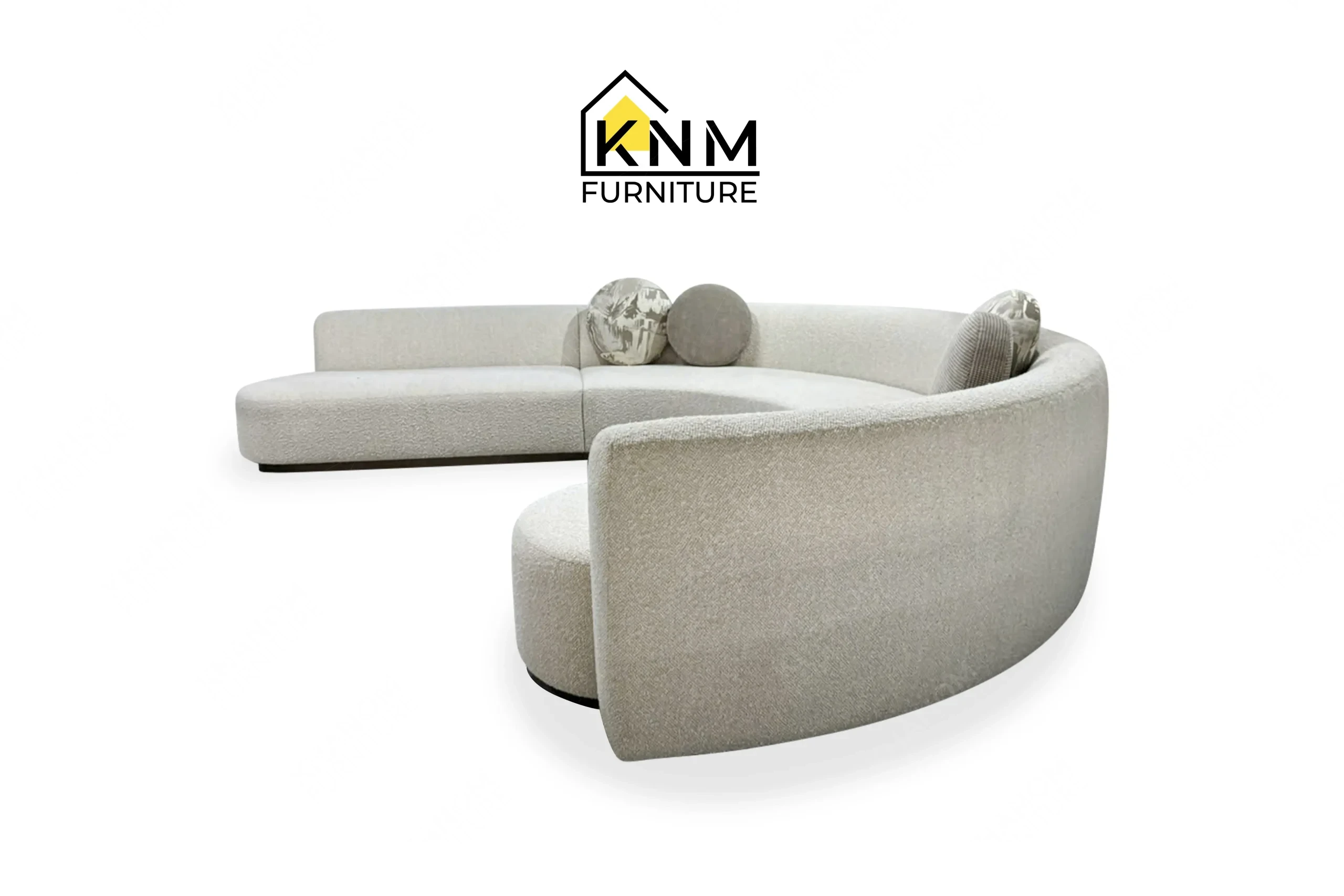The side profile of the curved Opuzen fabric sectional sofa highlights the structural depth and tight back upholstery specified by Khanom Furniture.