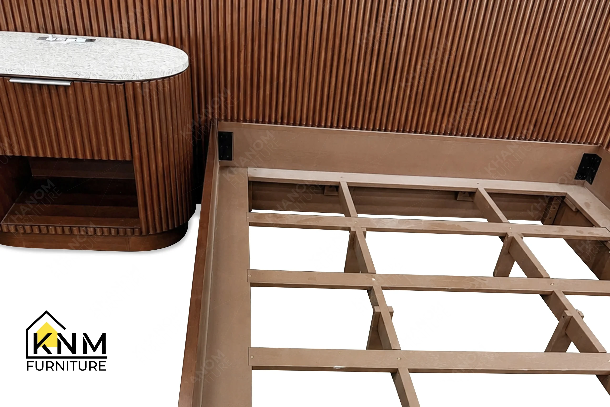 A technical detail of the hardwood tambour double queen bed from Khanom Furniture, describing the internal heavy-duty KD bolts and slatted frame.