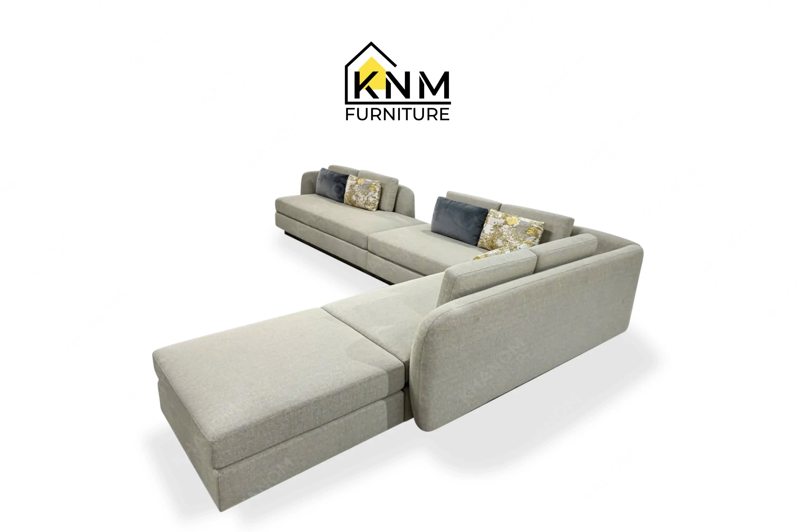 This rear view captures the continuous tight back upholstery of the modular Erica Shamrock sectional sofa engineered by Khanom Furniture.