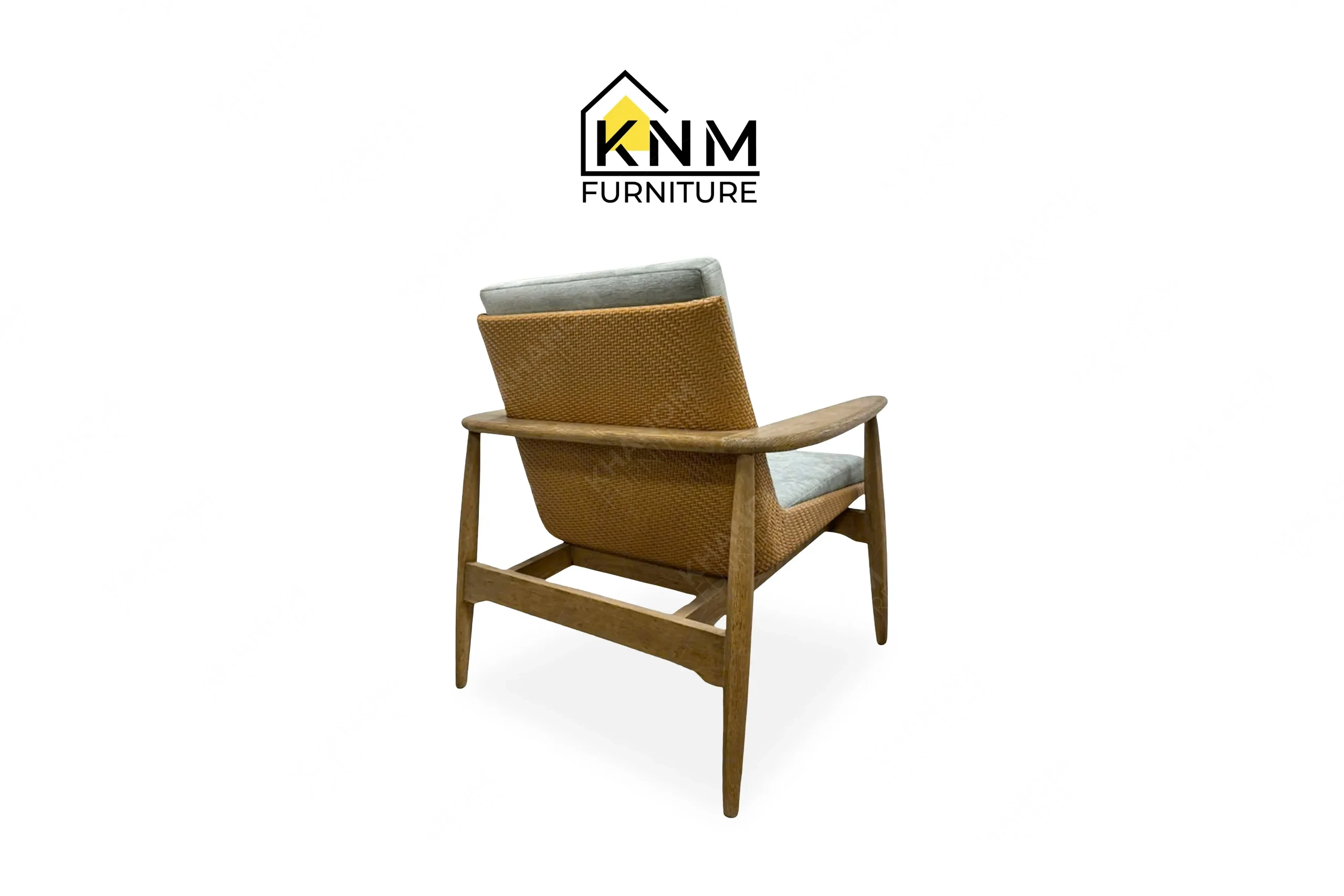 An alternative rear perspective of the white oak synthetic caning lounge chair highlights the robust joinery executed by Khanom Furniture.