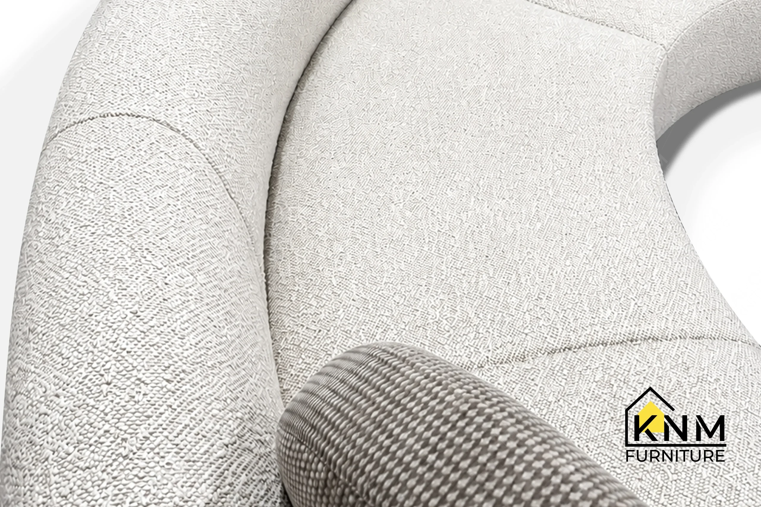 The surface texture detail of the curved Opuzen fabric sectional sofa manufactured by Khanom Furniture reveals the recessed Bronze Granex metal base.
