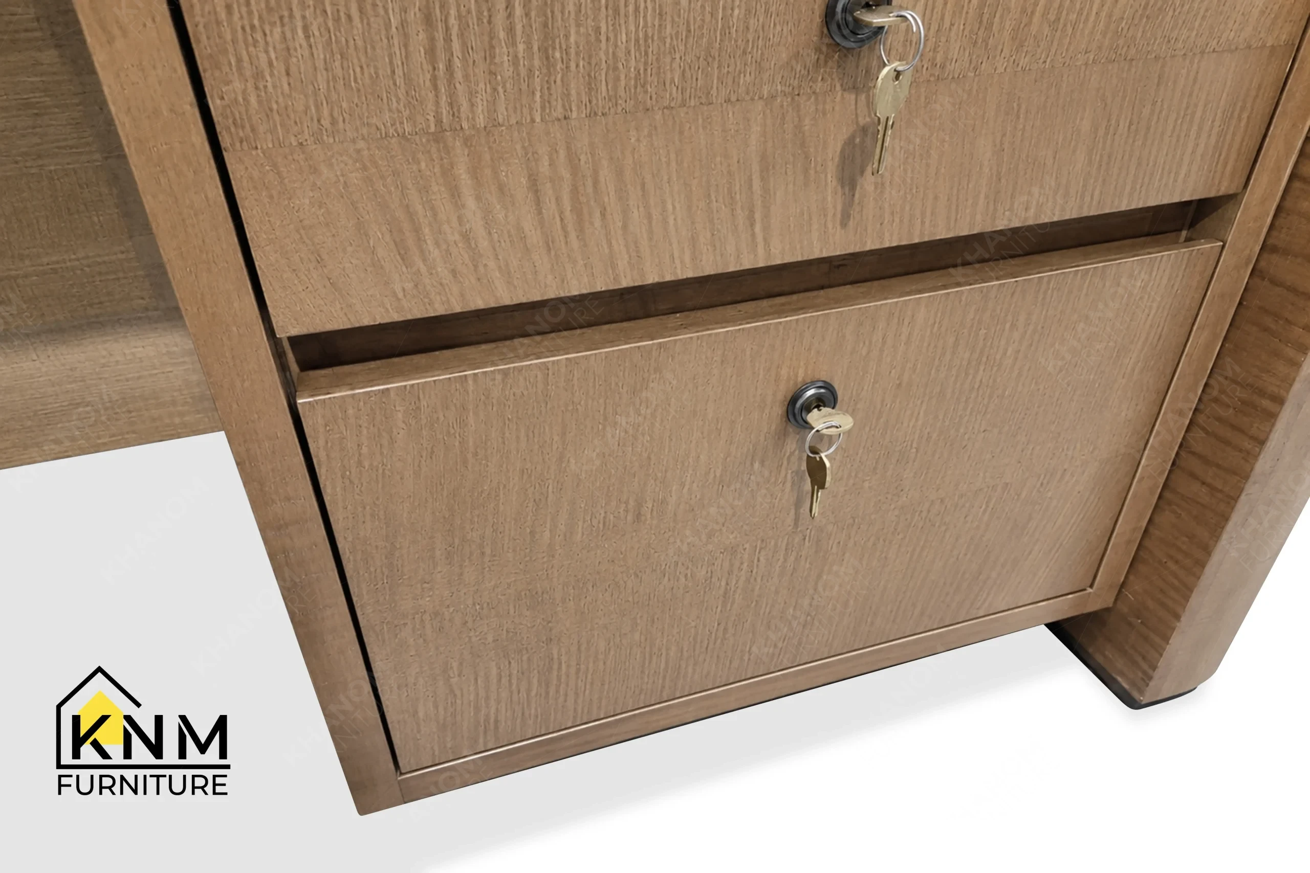 A technical detail of the figured walnut lobby concierge desk from Khanom Furniture, describing the bronze camlocks and flush drawer fronts.