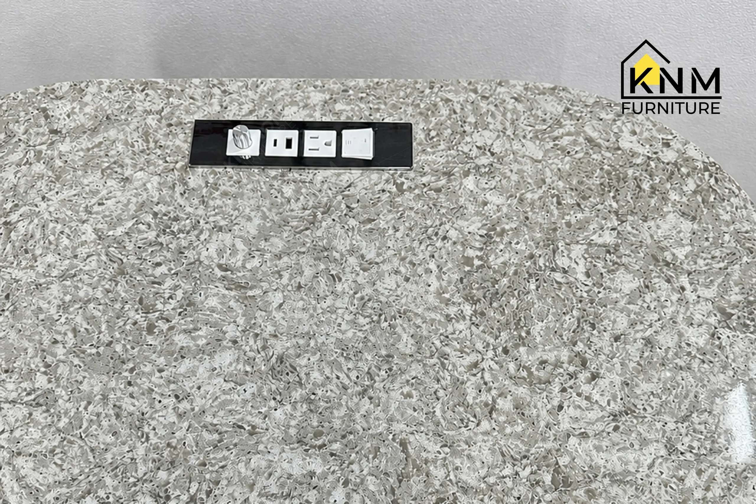 The surface texture detail of the quartz top tambour queen nightstand manufactured by Khanom Furniture reveals the polished finish of the Cambria Quartz.
