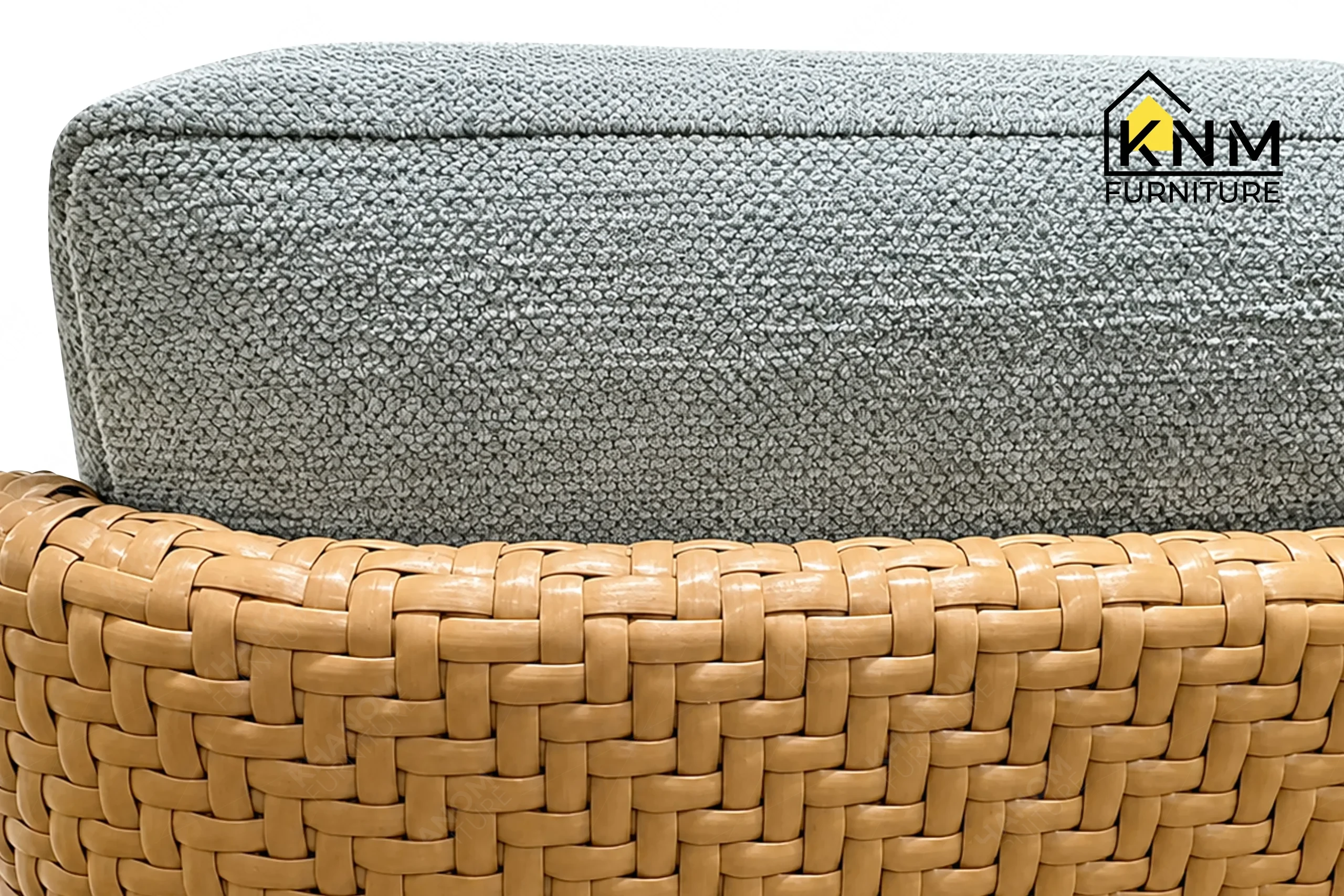 A detailed material zoom of the white oak synthetic caning lounge chair by Khanom Furniture, showing the open grain finish adjacent to the fabric and caning.
