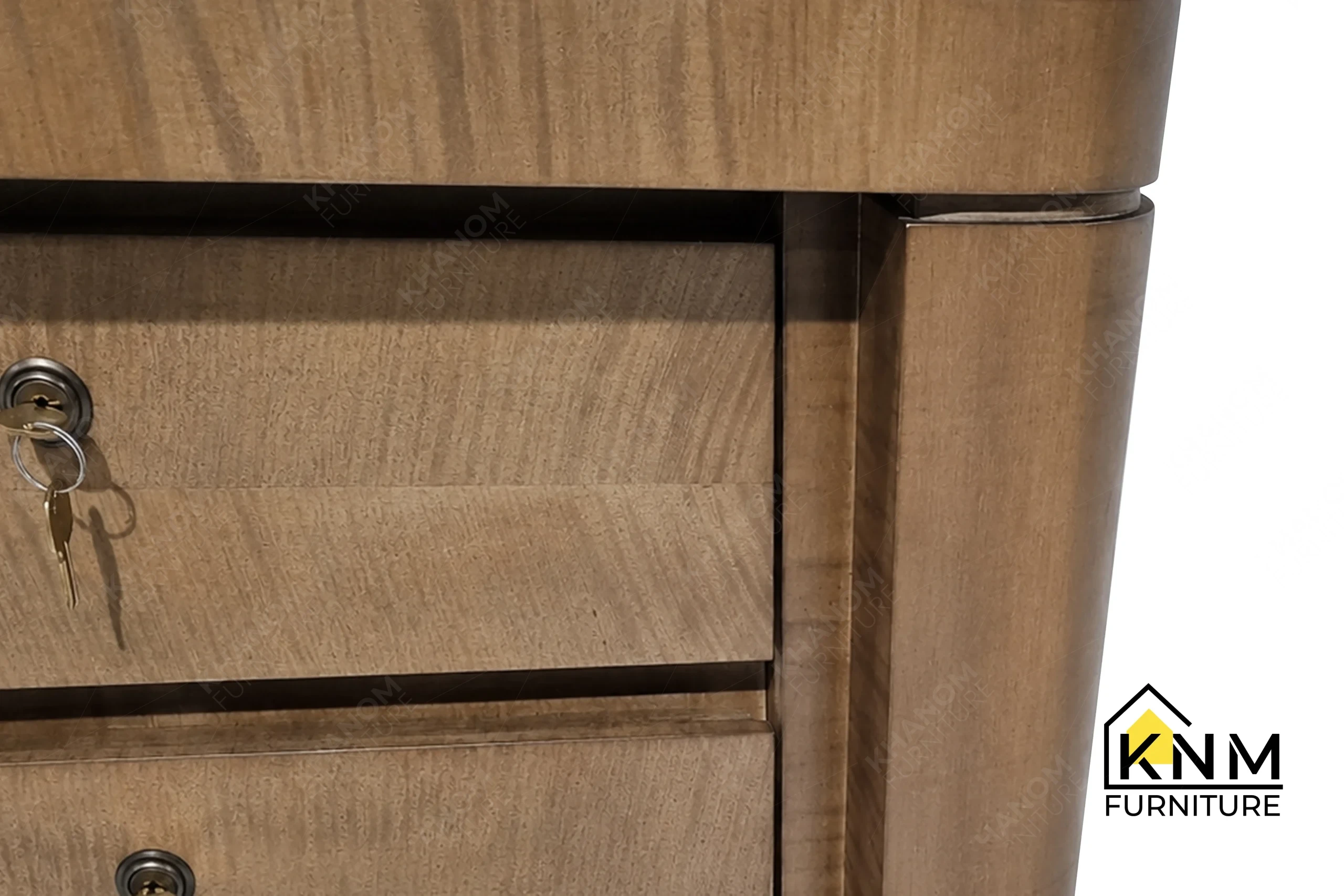 The surface texture detail of the figured walnut lobby concierge desk manufactured by Khanom Furniture reveals the flush integration of the Gypsum inlay.