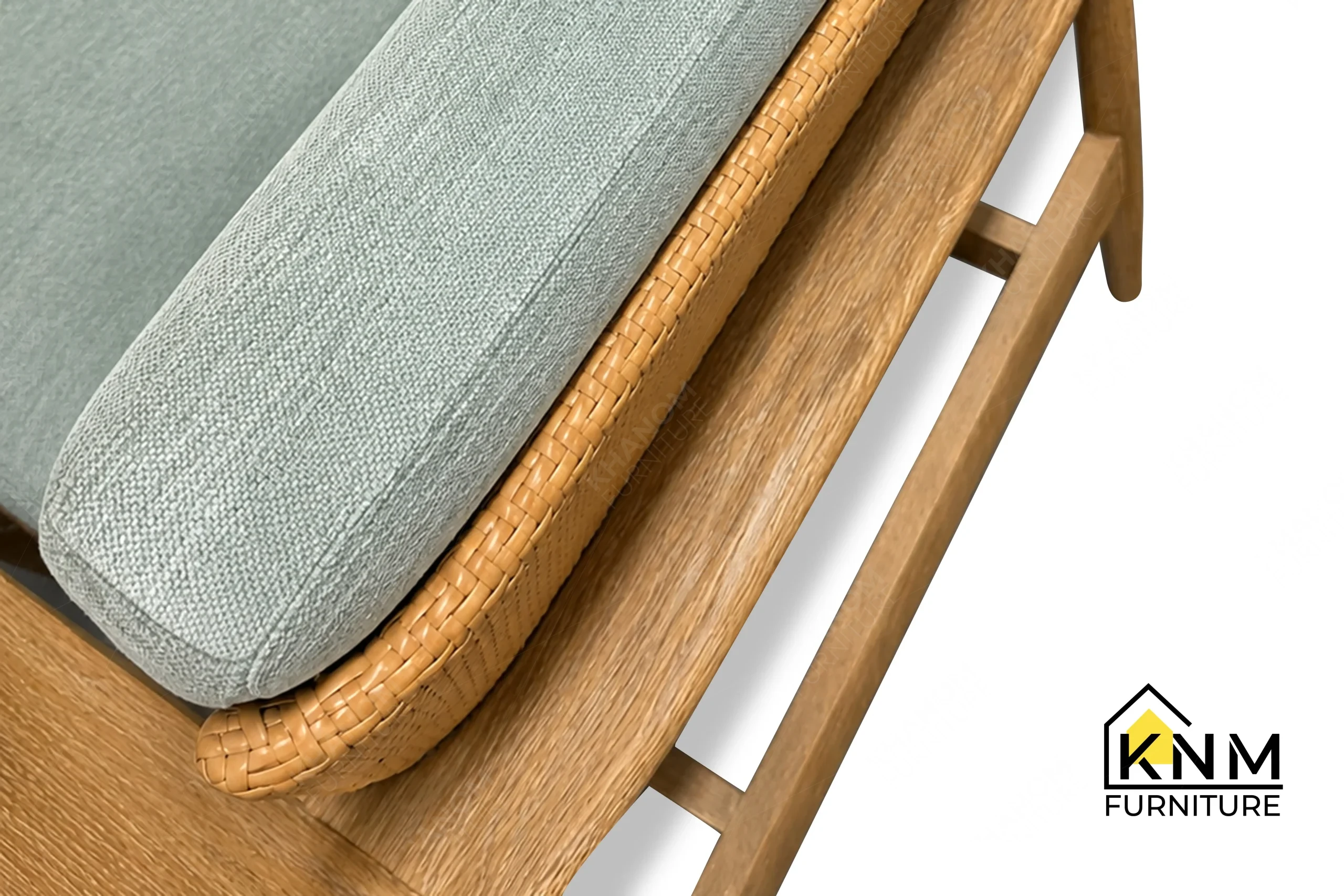 A technical detail of the white oak synthetic caning lounge chair from Khanom Furniture, describing the inset caning boundary and tight seat upholstery.