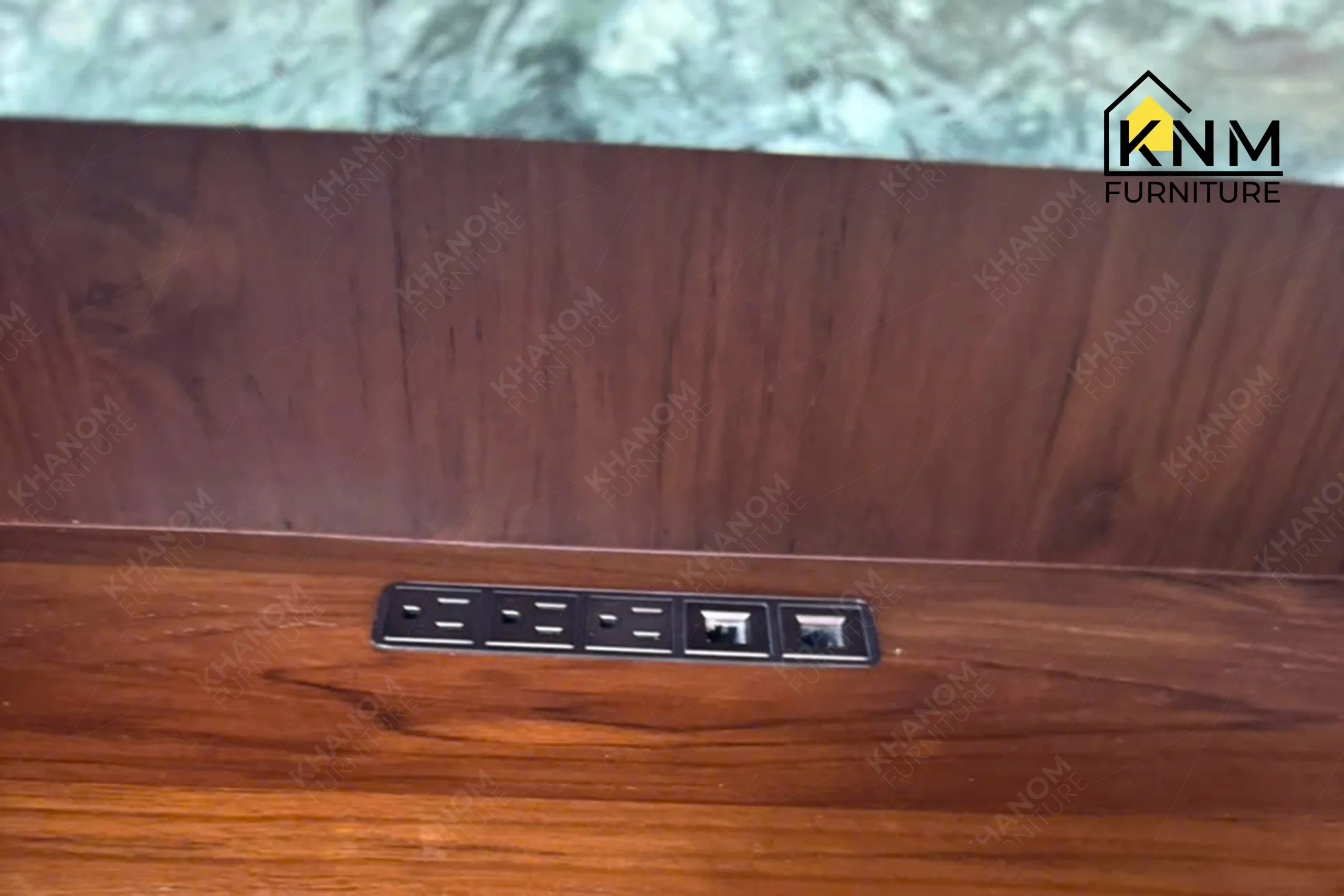 A technical detail of the stone top teak valet bell desk from Khanom Furniture, describing the keyed cylinder locks and teak drawer fronts.