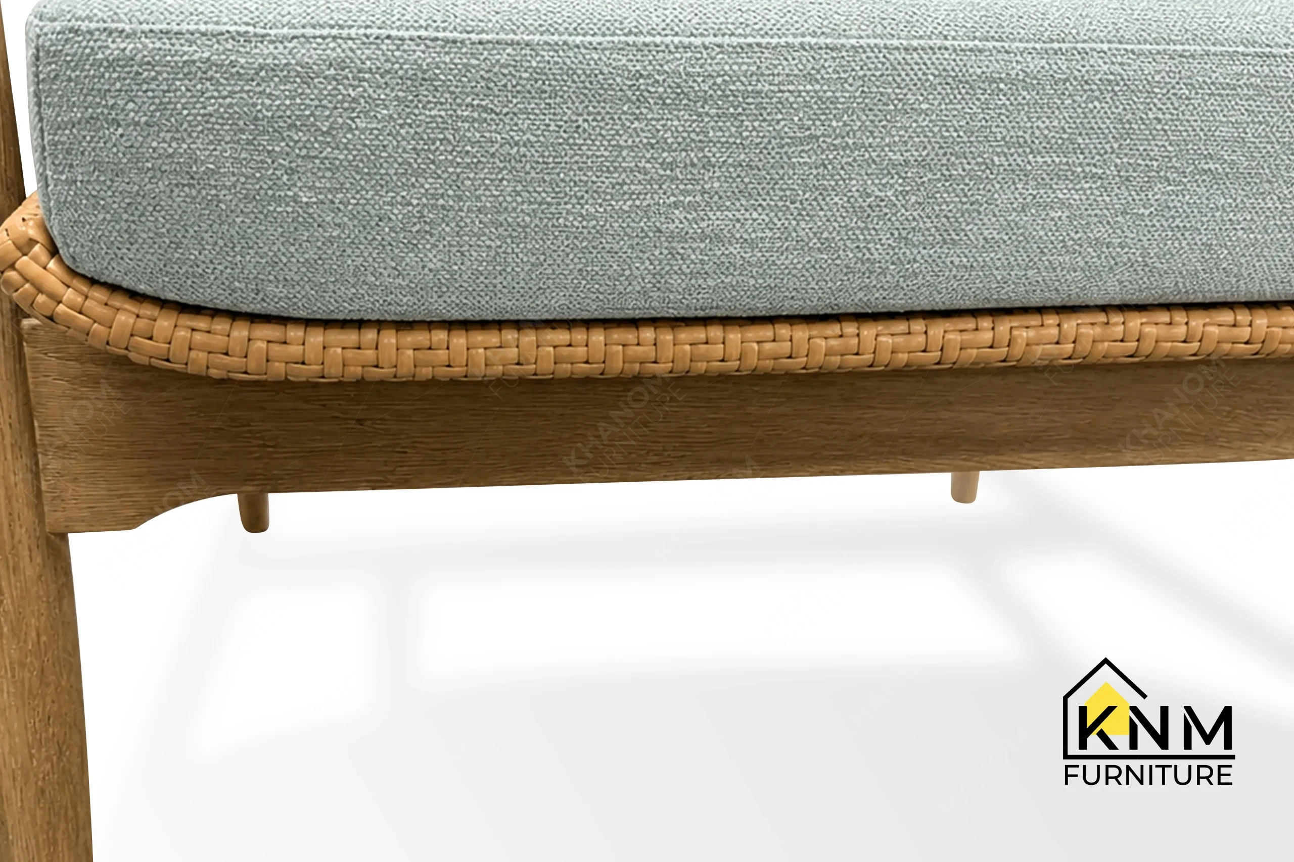 The surface texture detail of the white oak synthetic caning lounge chair manufactured by Khanom Furniture reveals the protective Teflon tap-in glides.