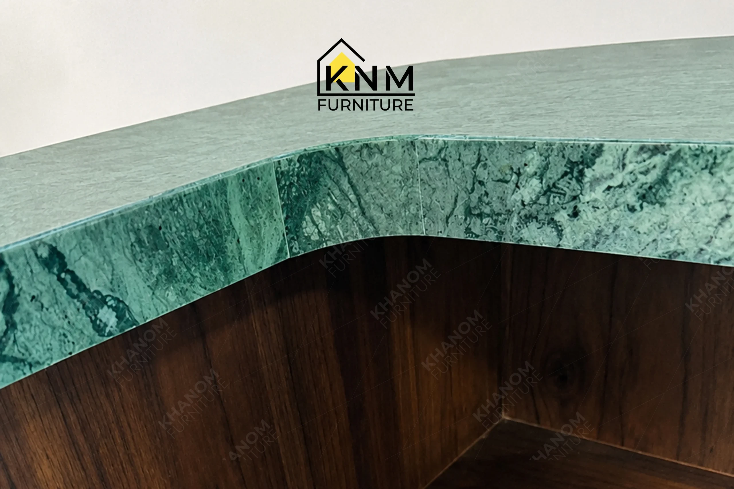 The surface texture detail of the stone top teak valet bell desk manufactured by Khanom Furniture reveals the protective finish on the solid wood.