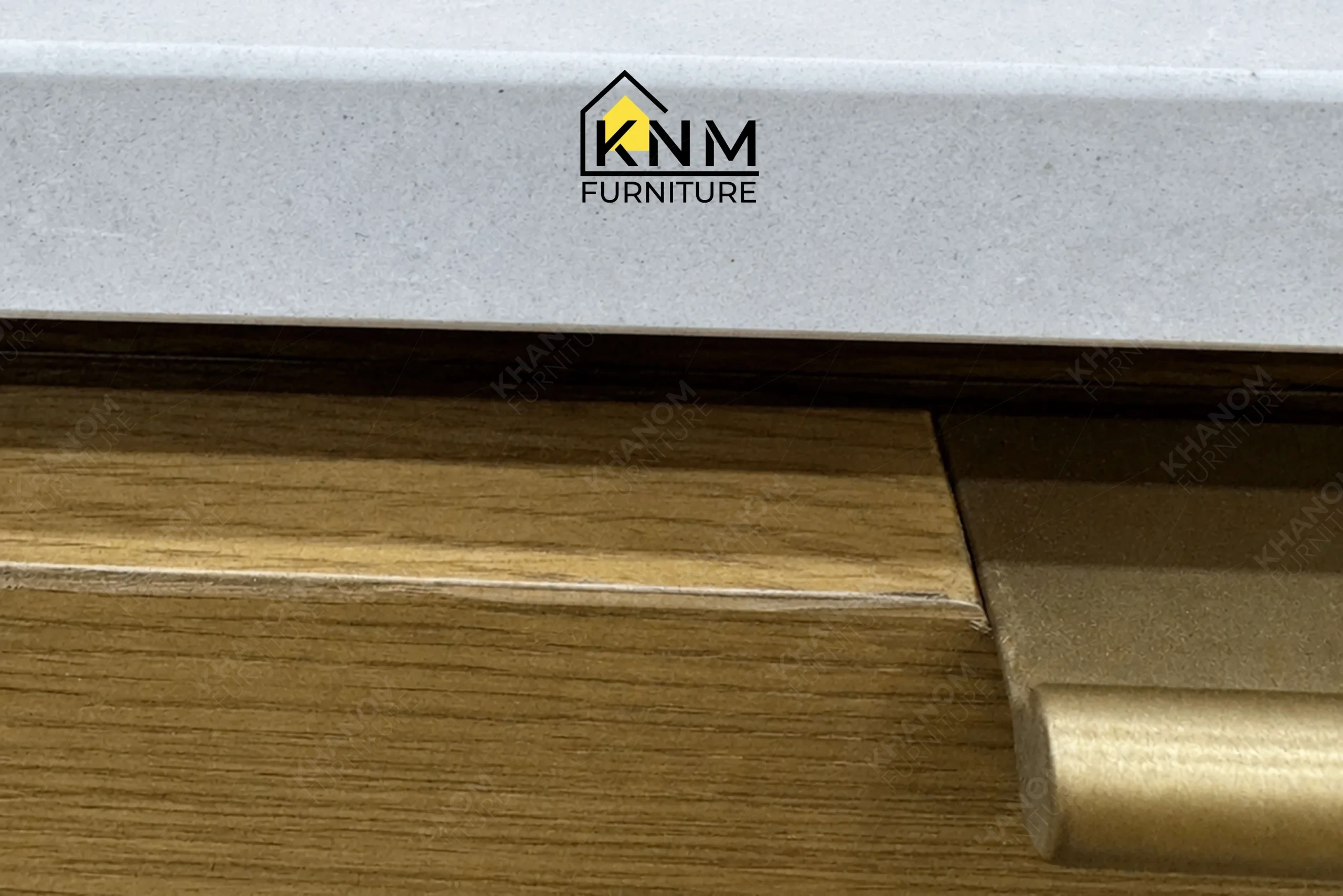 A technical detail of the Vicostone top white oak console desk from Khanom Furniture, describing the squared drawer edges and custom Platinum Nickel pulls.