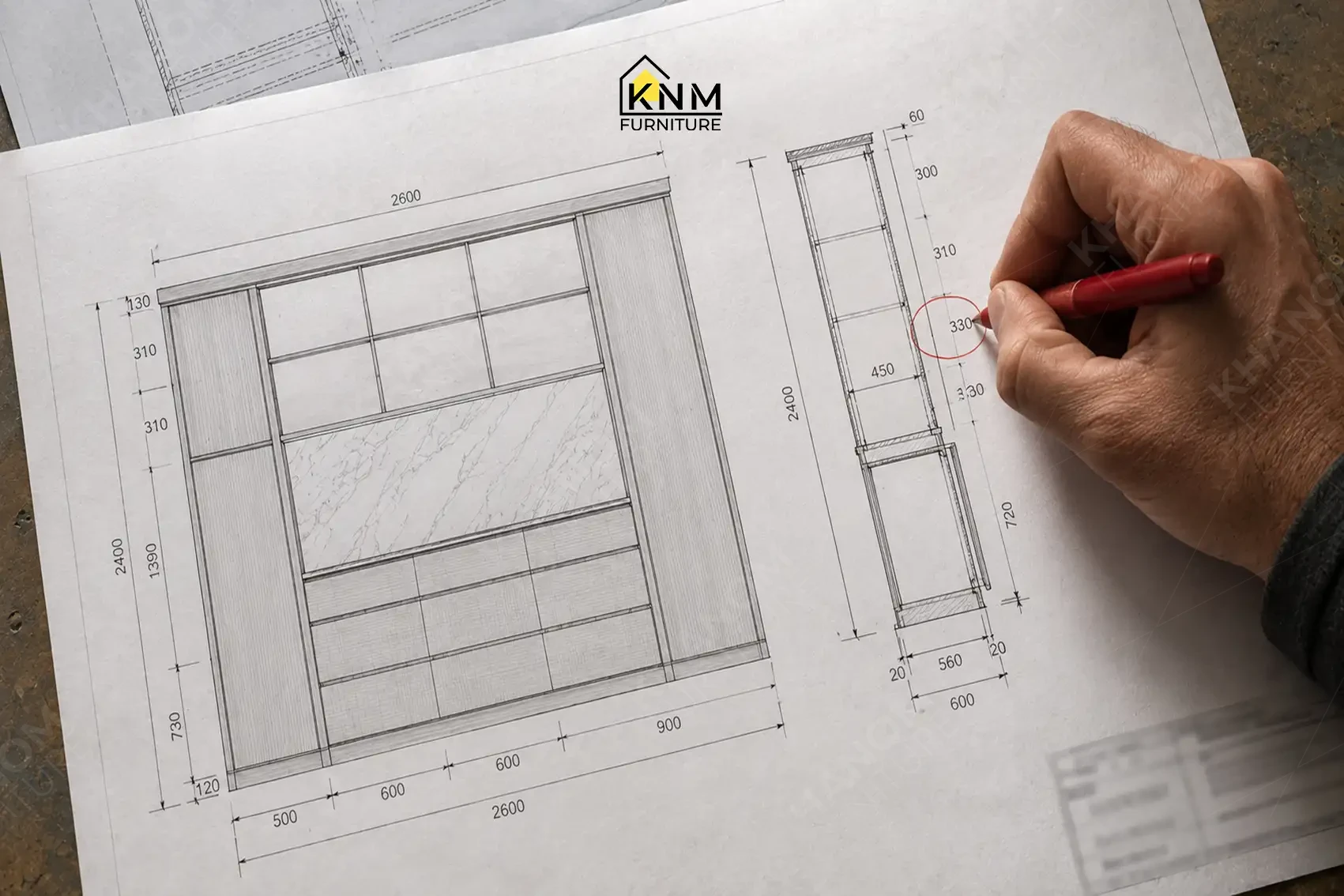 Close up of a hand making red pen markups on a technical shop drawing for cabinet dimensions at Khanom Furniture (KNM Furniture), a hospitality furniture factory Vietnam.
