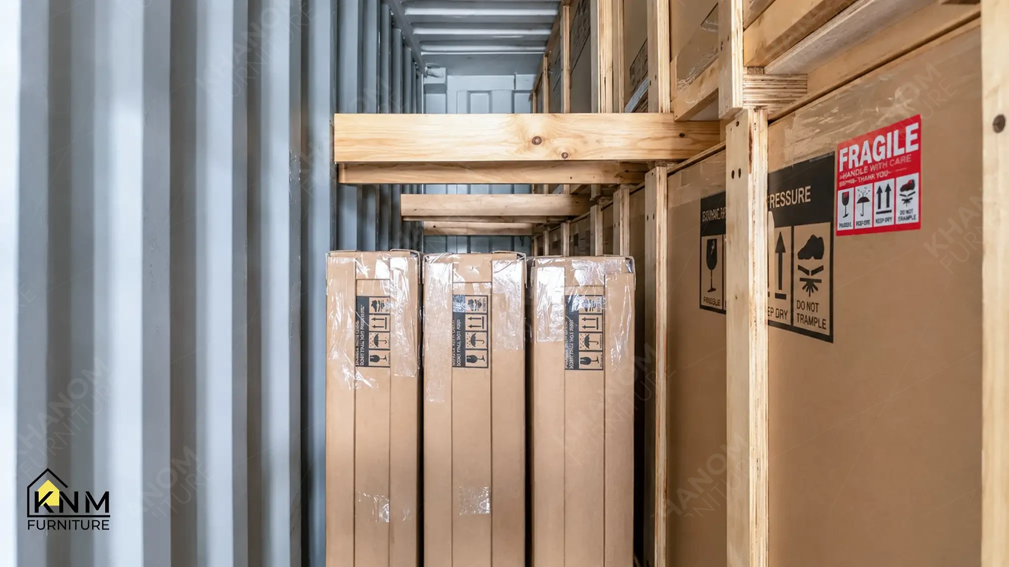 Vertical furniture components wrapped in PE film and cardboard, secured with wooden battens inside 40HQ container — KNM Furniture Vietnam