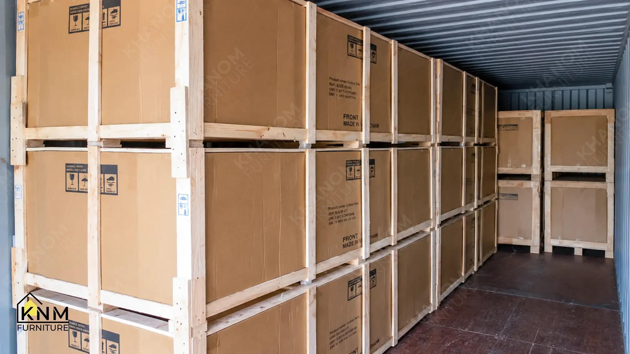 Full 40HQ container loaded with wooden-crated casegood units stacked 3-tiers along the container wall — FF&E export scale, KNM Furniture Vietnam