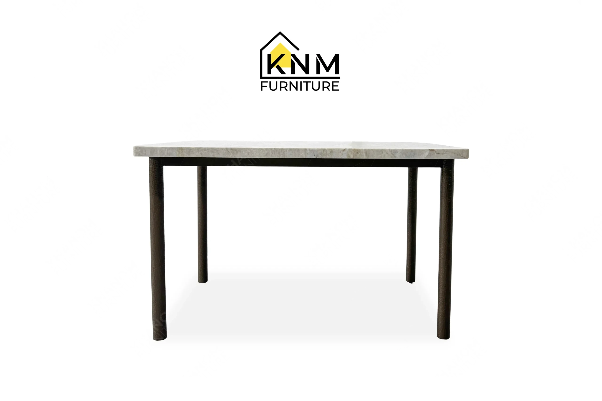 This front view displays the 4-top stone rectangular dining table manufactured by Khanom Furniture, highlighting the inset Hammered Bronze legs and stone surface.