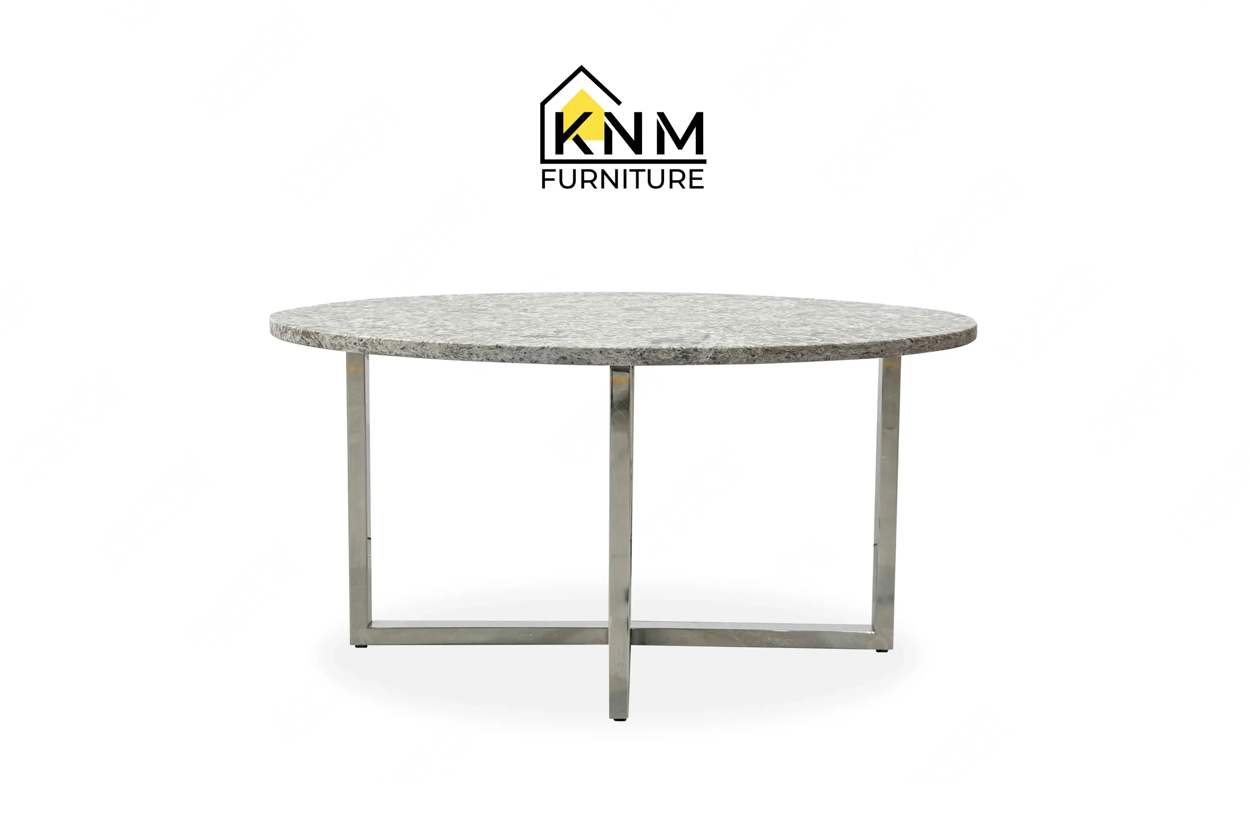 This front view displays the Cambria quartz chrome cocktail table manufactured by Khanom Furniture, highlighting the cross-brace base and round stone top.
