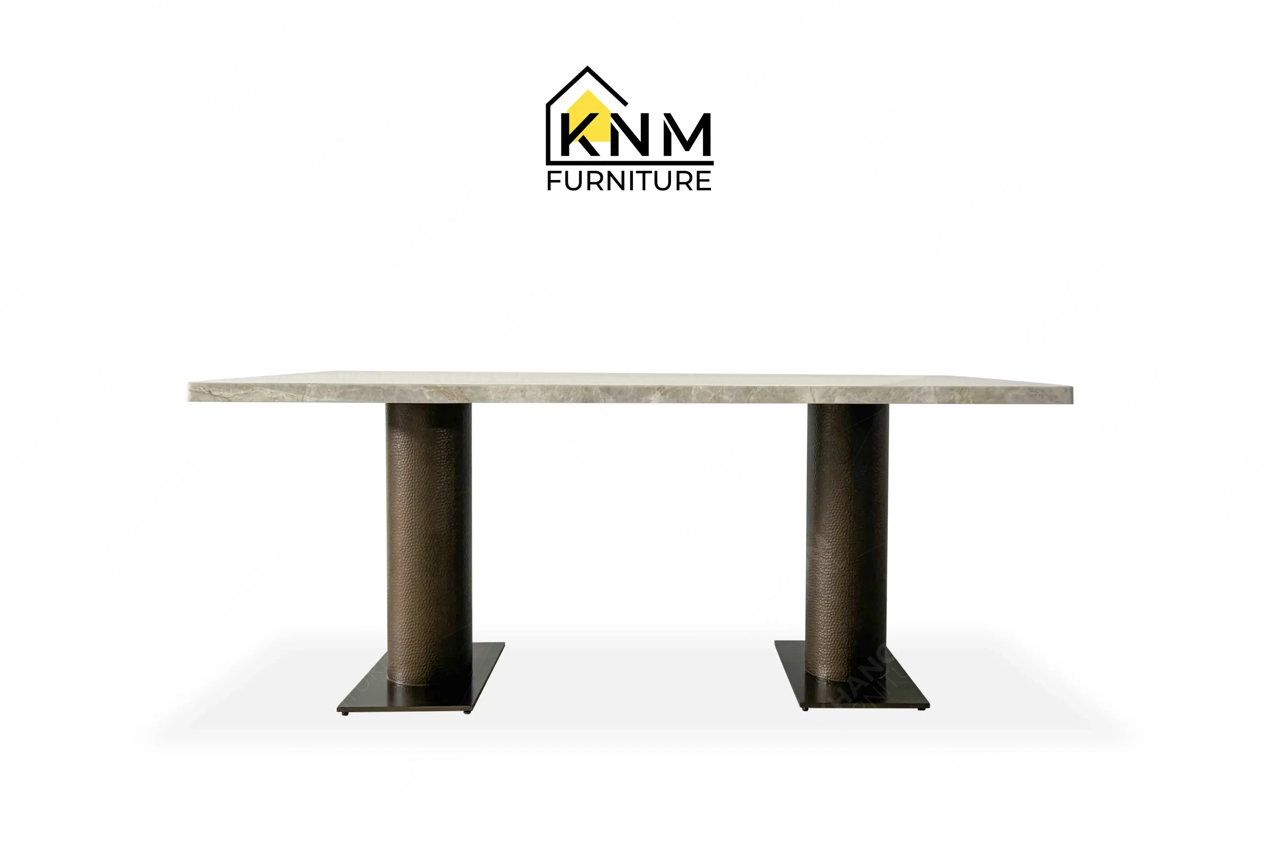 This front view displays the double pedestal stone dining table manufactured by Khanom Furniture, highlighting the dual Hammered Bronze columns and expansive stone surface.