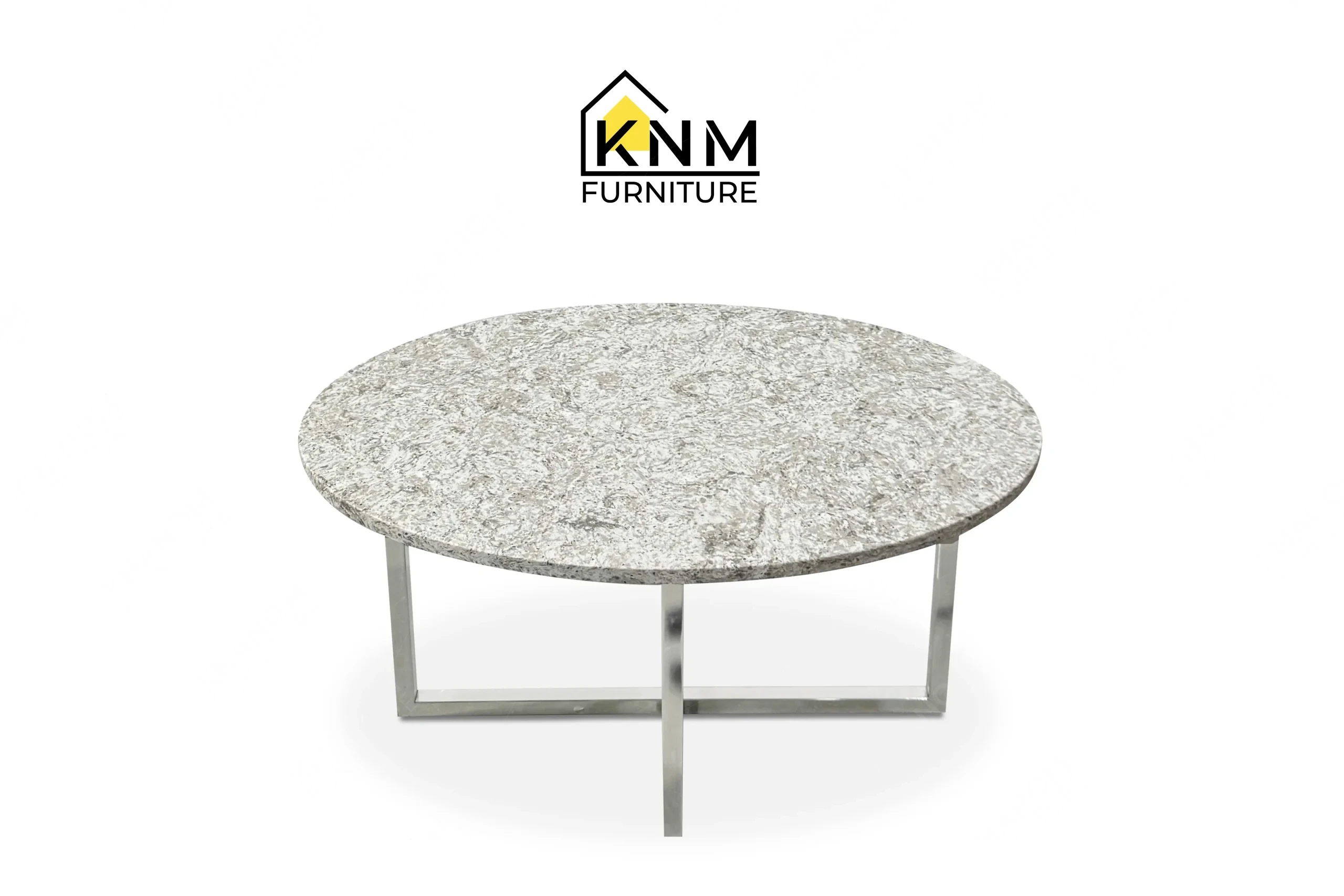 A perspective view illustrating the polished chrome base and stone top of the Cambria quartz chrome cocktail table produced by Khanom Furniture.
