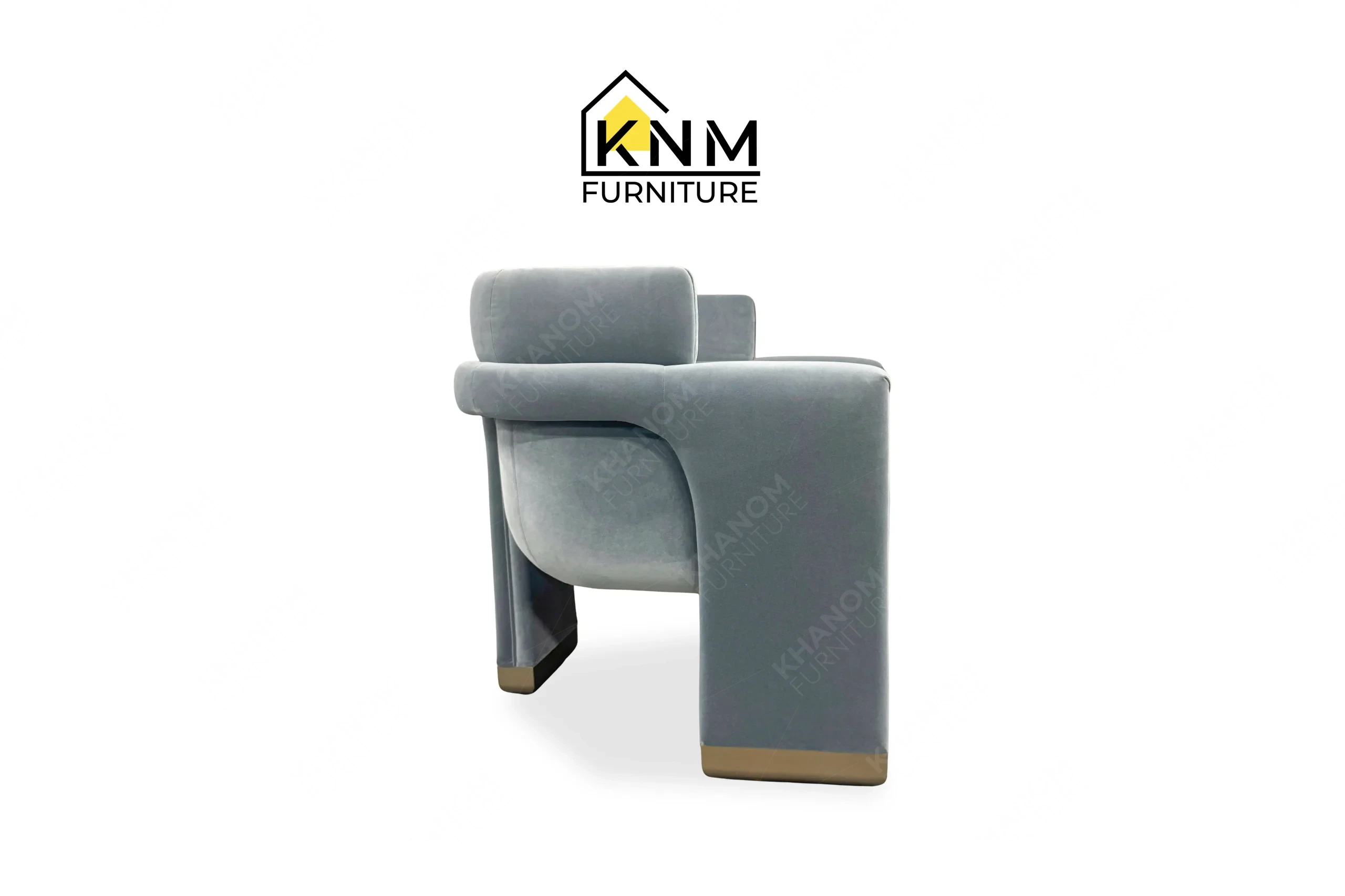 The side profile of the Momentum fabric upholstered lounge chair highlights the solid architectural armrests specified by Khanom Furniture.
