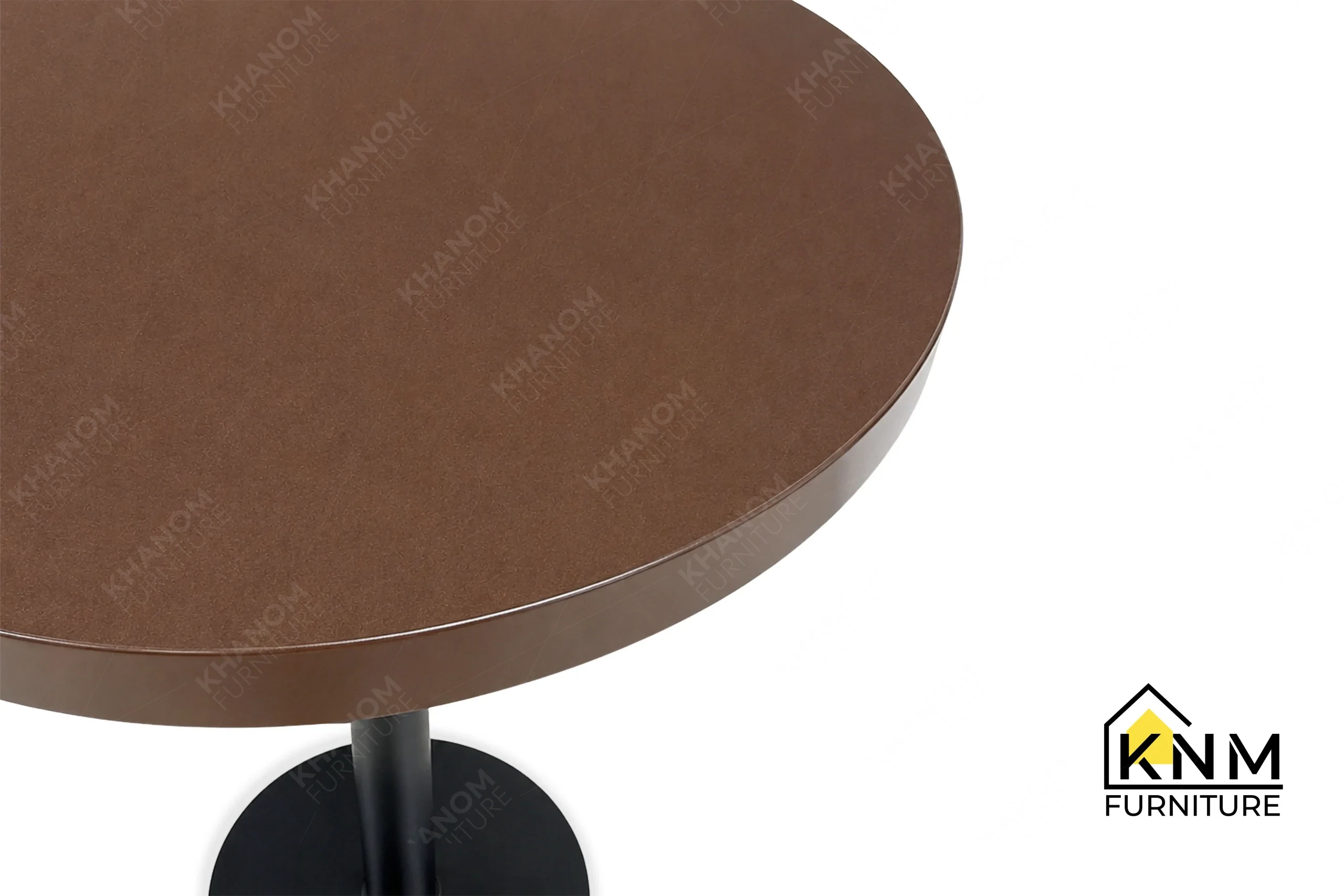 A detailed material zoom of the Prismatic powdercoat metal bar table by Khanom Furniture, showing the reduced-gloss hammered texture on the surface.