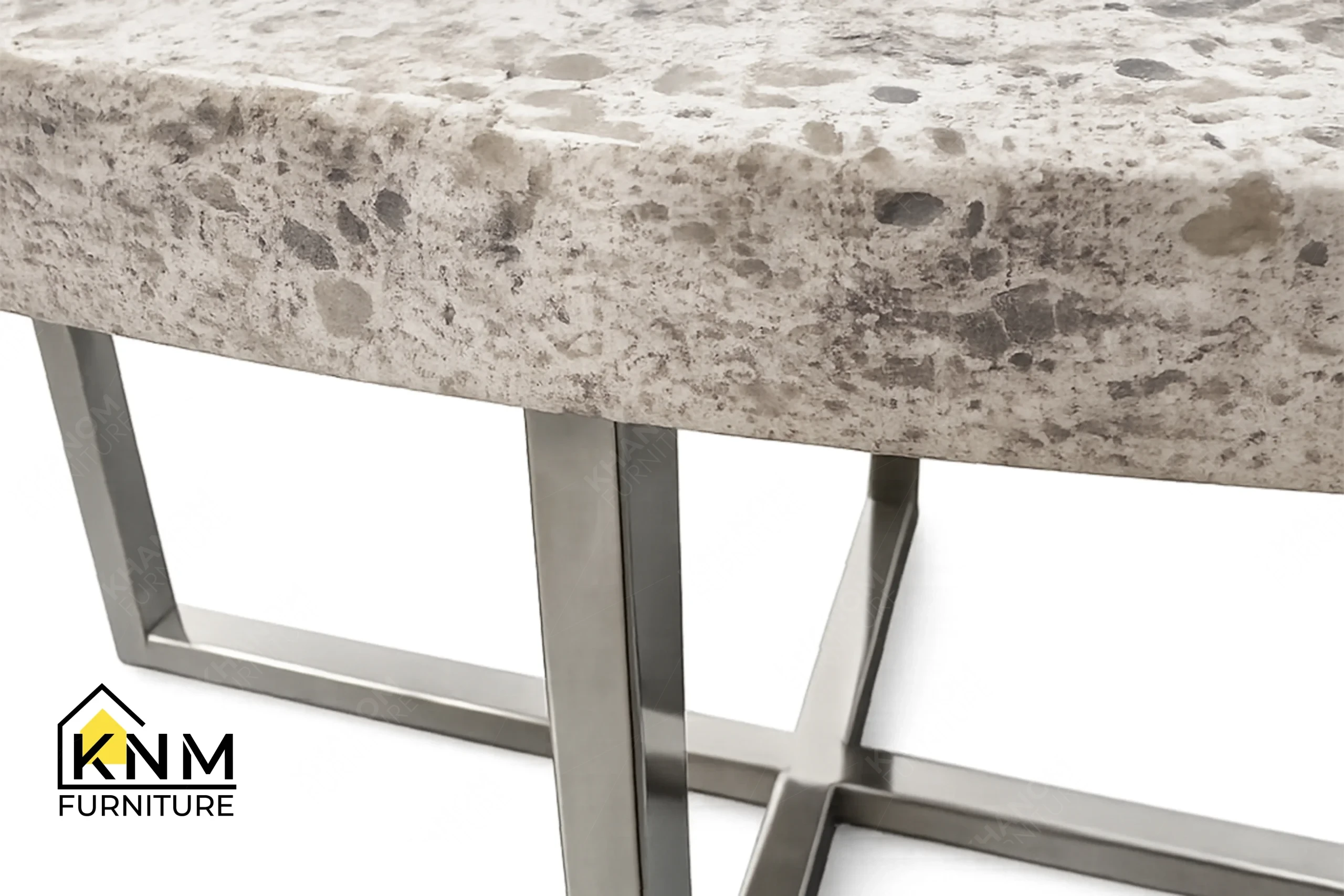 A technical detail of the Cambria quartz chrome cocktail table from Khanom Furniture, describing the Polished Chrome plating on the metal frame.