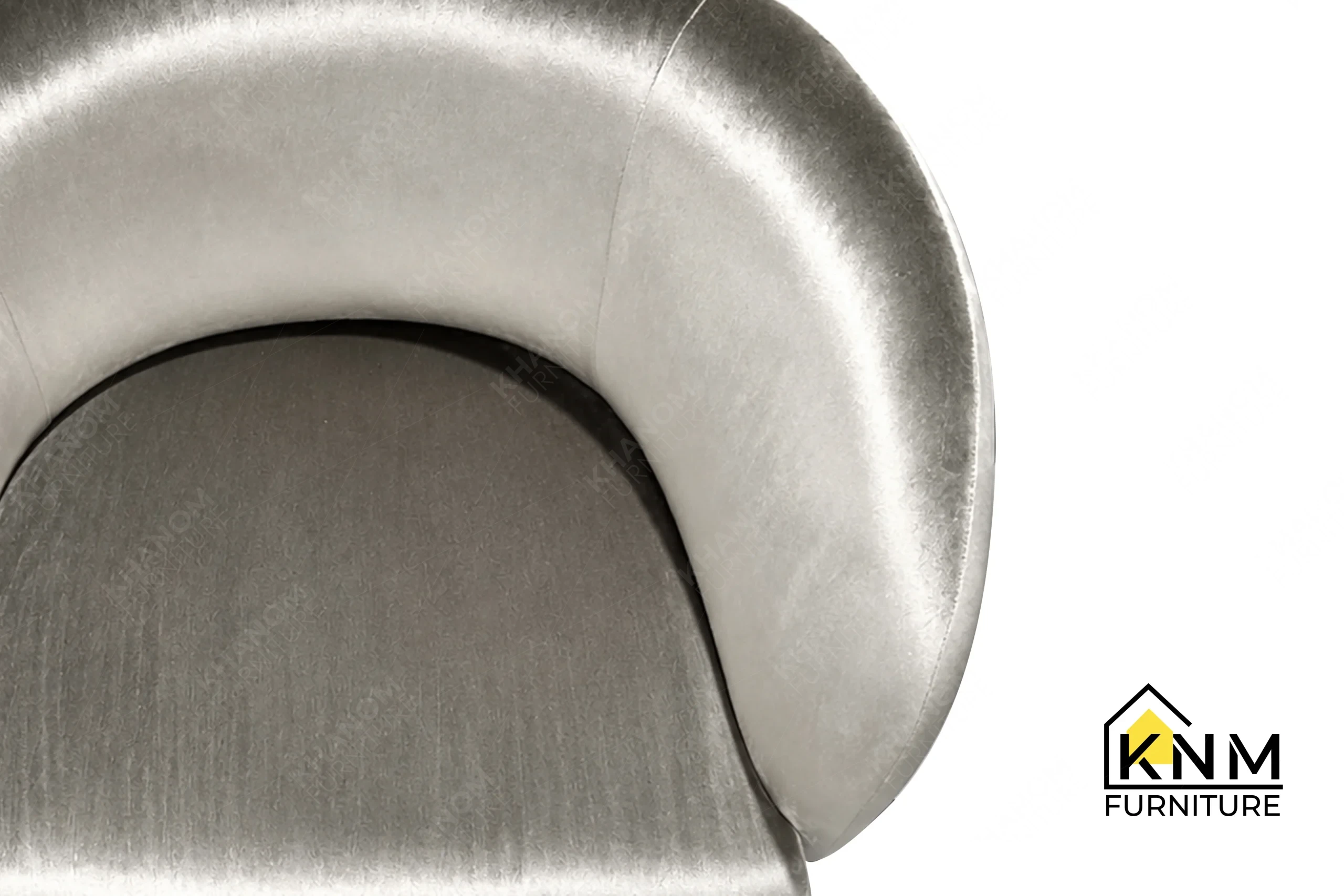 A detailed material zoom of the Dedar fabric upholstered lounge chair by Khanom Furniture, showing the textured Dedar fabric weave.