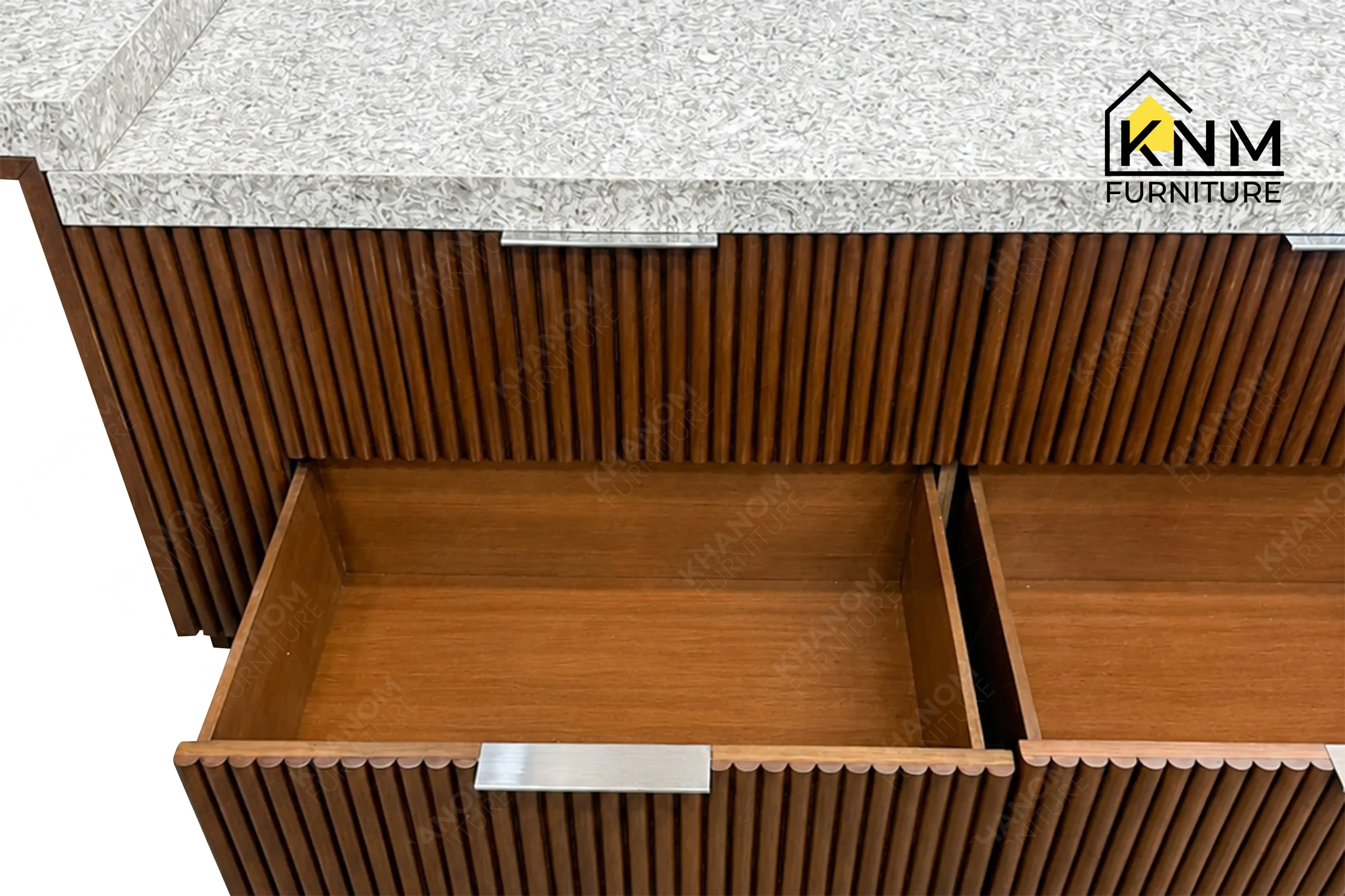 A detailed material zoom of the integrated quartz top tambour media desk by Khanom Furniture, showing the 2x2mm U-groove between the stone and wood.