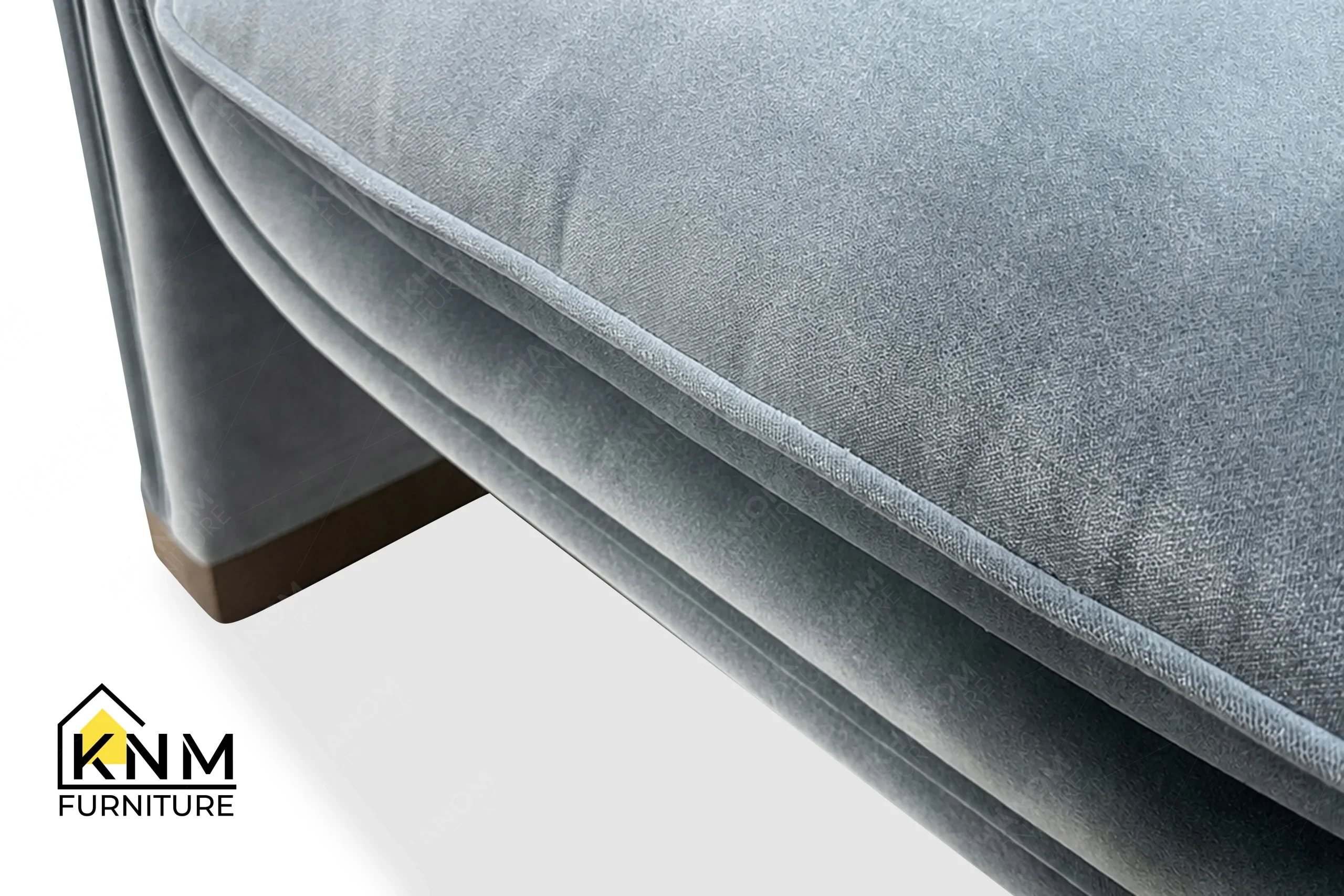 A detailed material zoom of the Momentum fabric upholstered lounge chair by Khanom Furniture, showing the soft texture of the Momentum fabric.