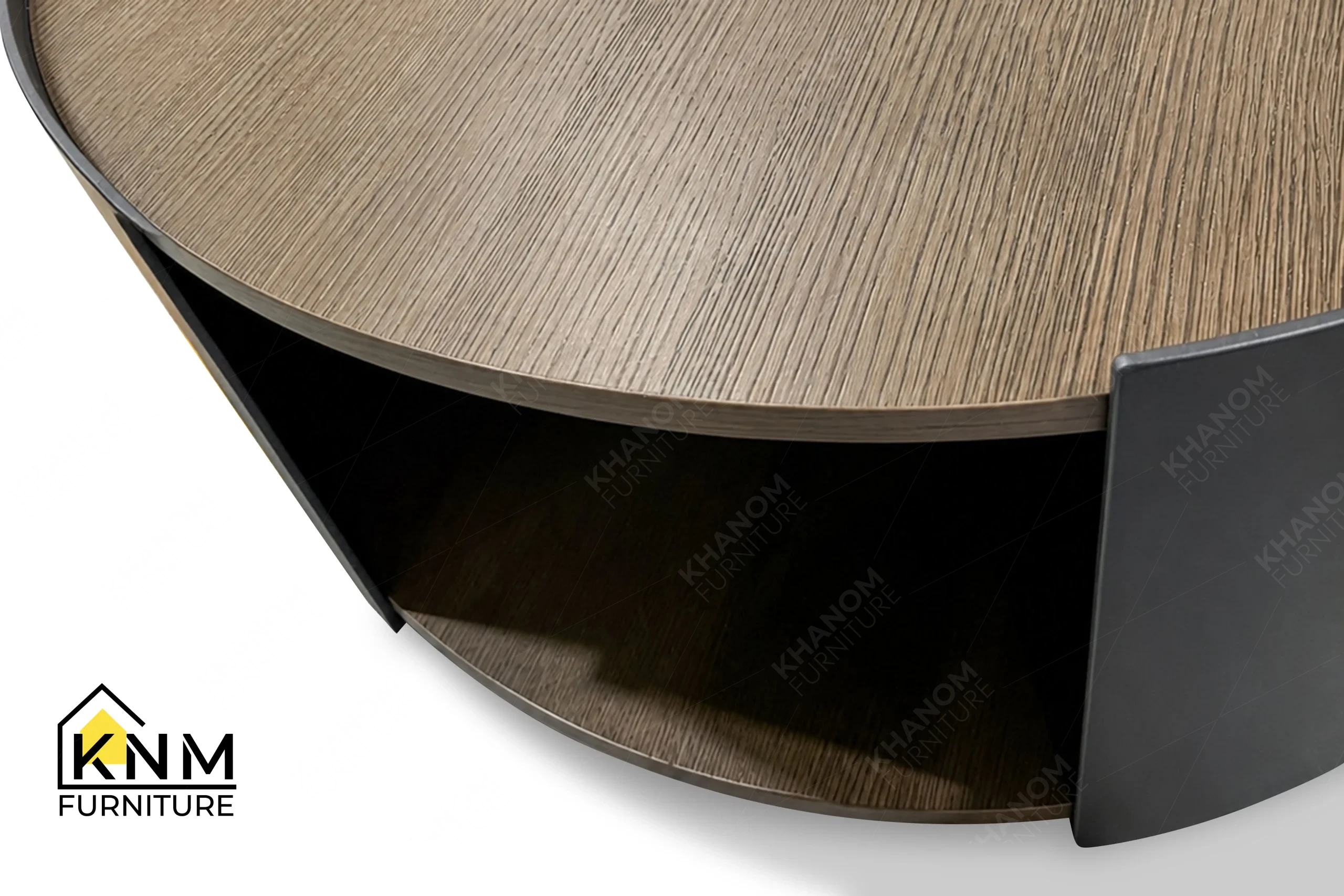 This rear view captures the continuous curved metal back of the quarter cut oak nesting coffee table engineered by Khanom Furniture.