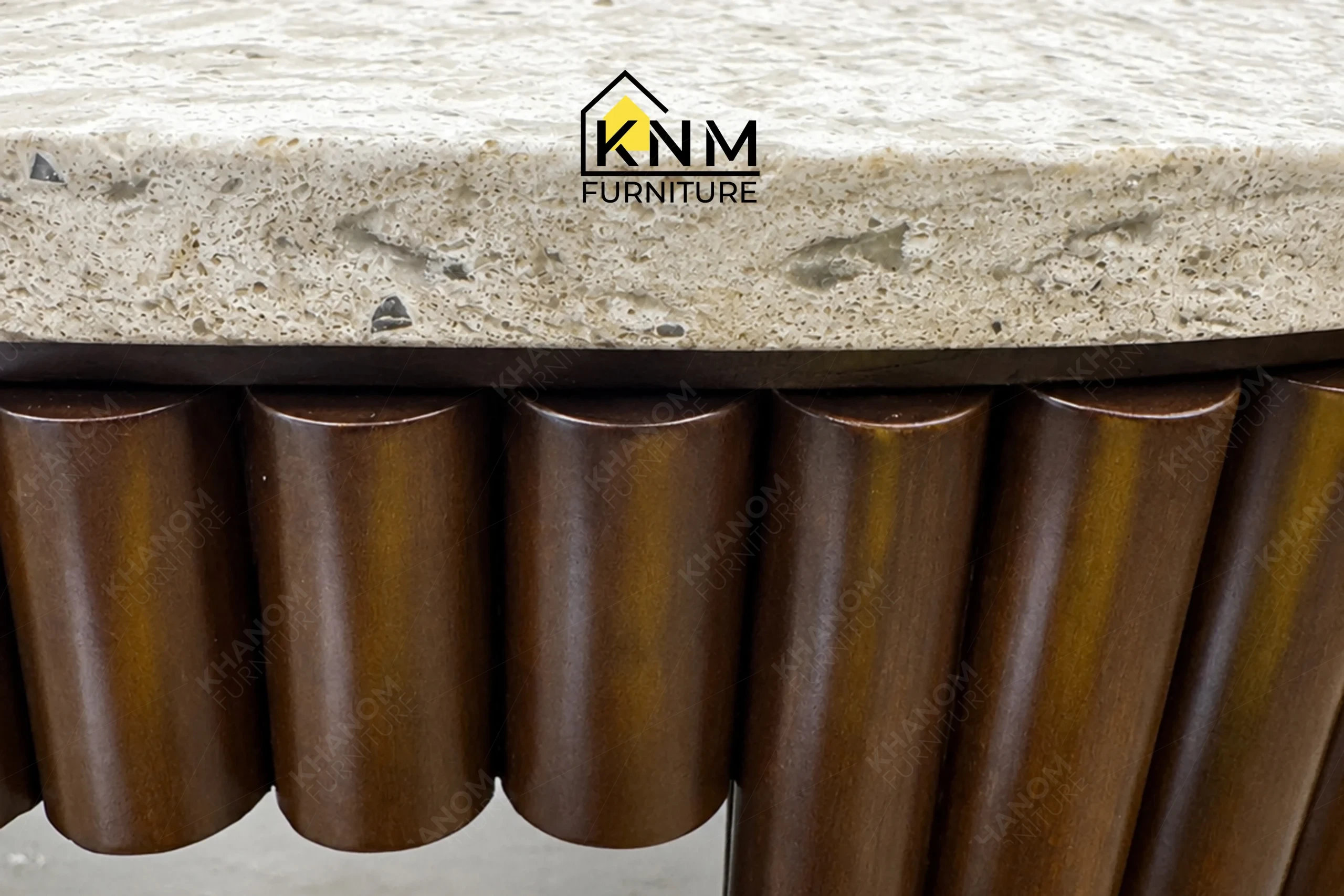 A detailed material zoom of the quartz top tambour king bed desk by Khanom Furniture, showing the milled solid beech wood adjacent to the quartz surface.