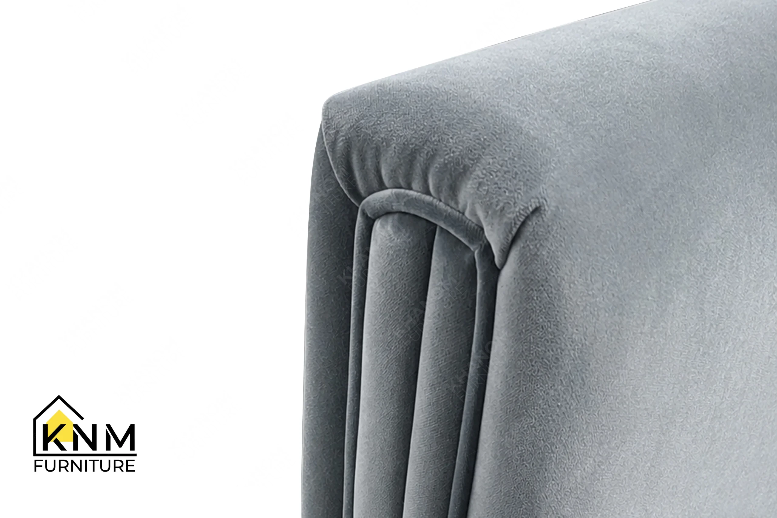 A technical detail of the Momentum fabric upholstered lounge chair from Khanom Furniture, describing the tailored piping along the armrests.