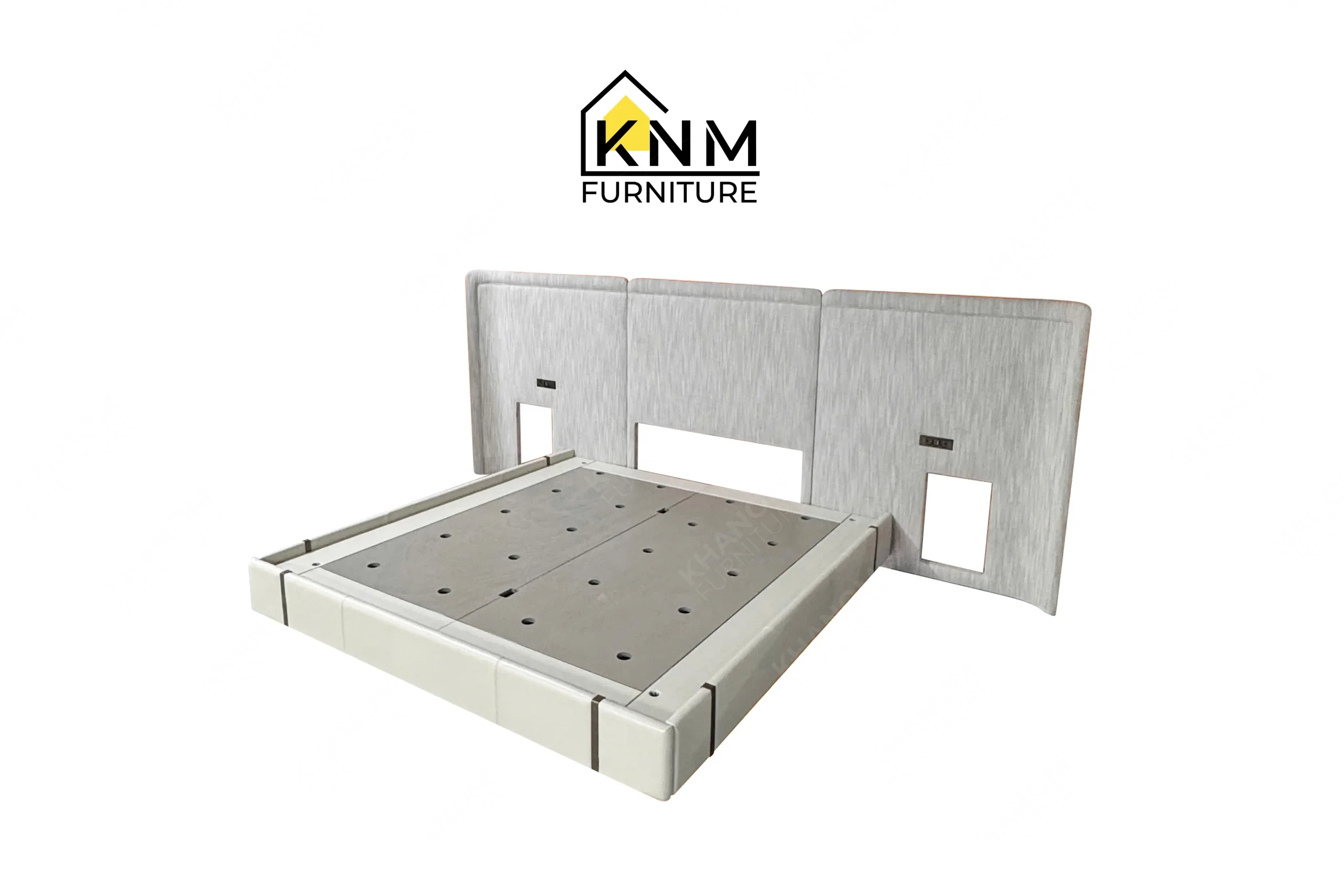 A perspective view illustrating the side rails and metal reveals of the upholstered hotel bed base and headboard produced by Khanom Furniture.