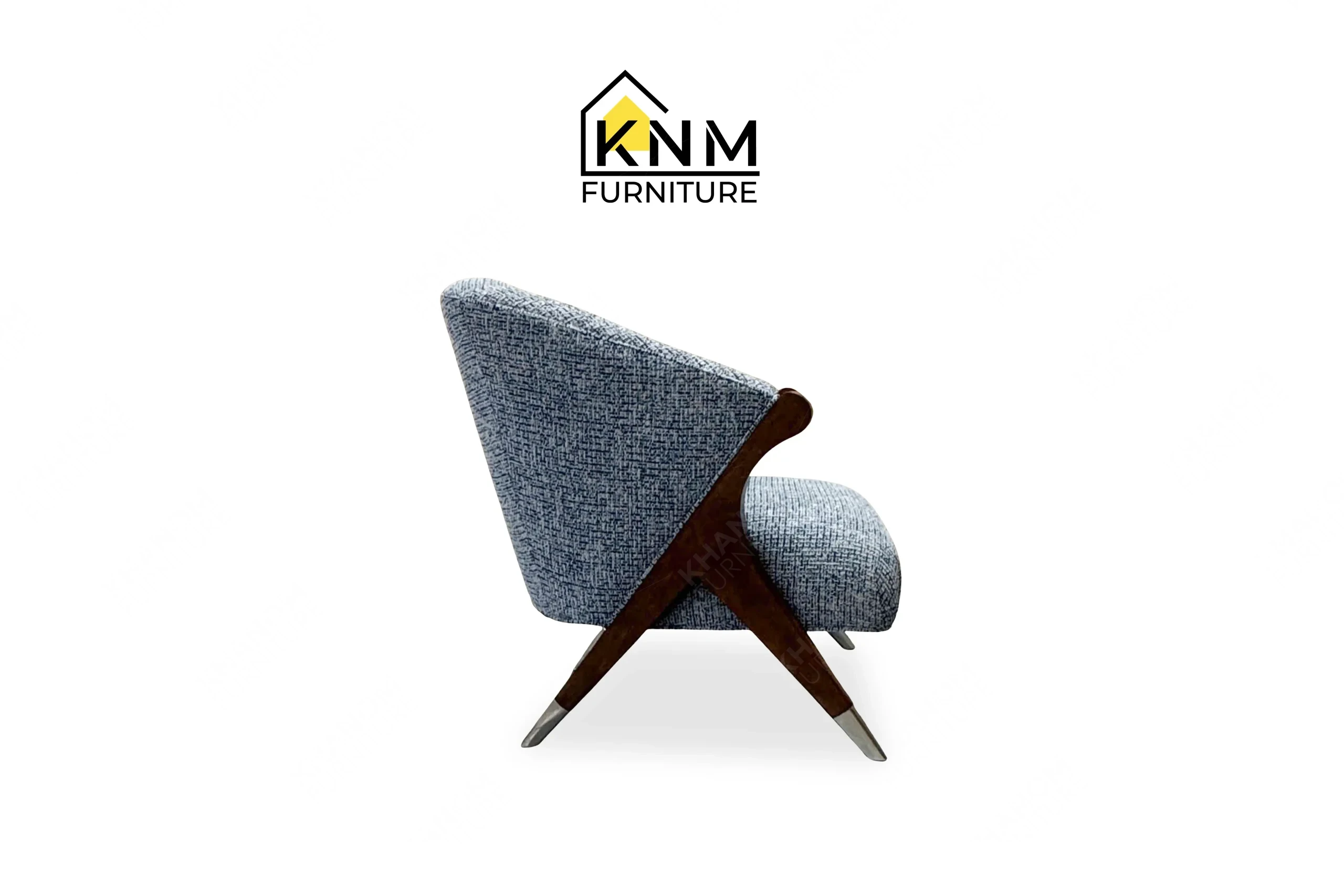 The side profile of the Fabricut upholstered hardwood lounge chair highlights the compass leg structure specified by Khanom Furniture.