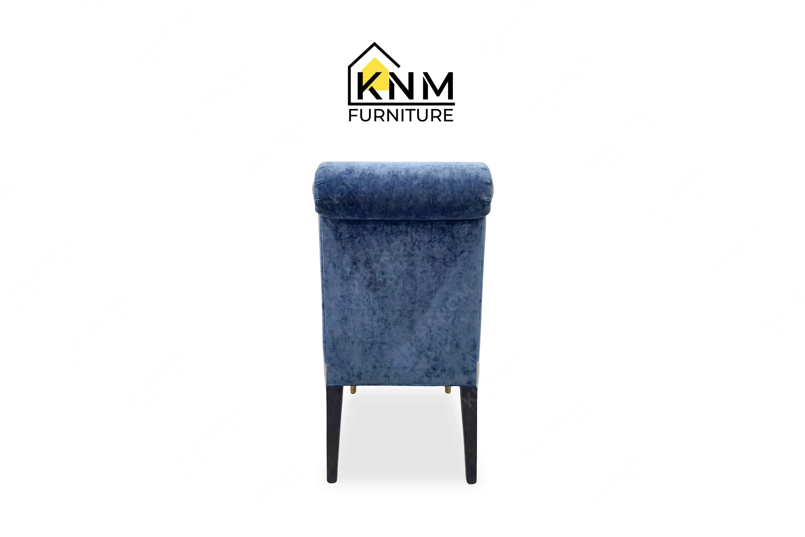 This rear view captures the continuous velvet upholstery on the multi-COM rolled back dining chair engineered by Khanom Furniture.