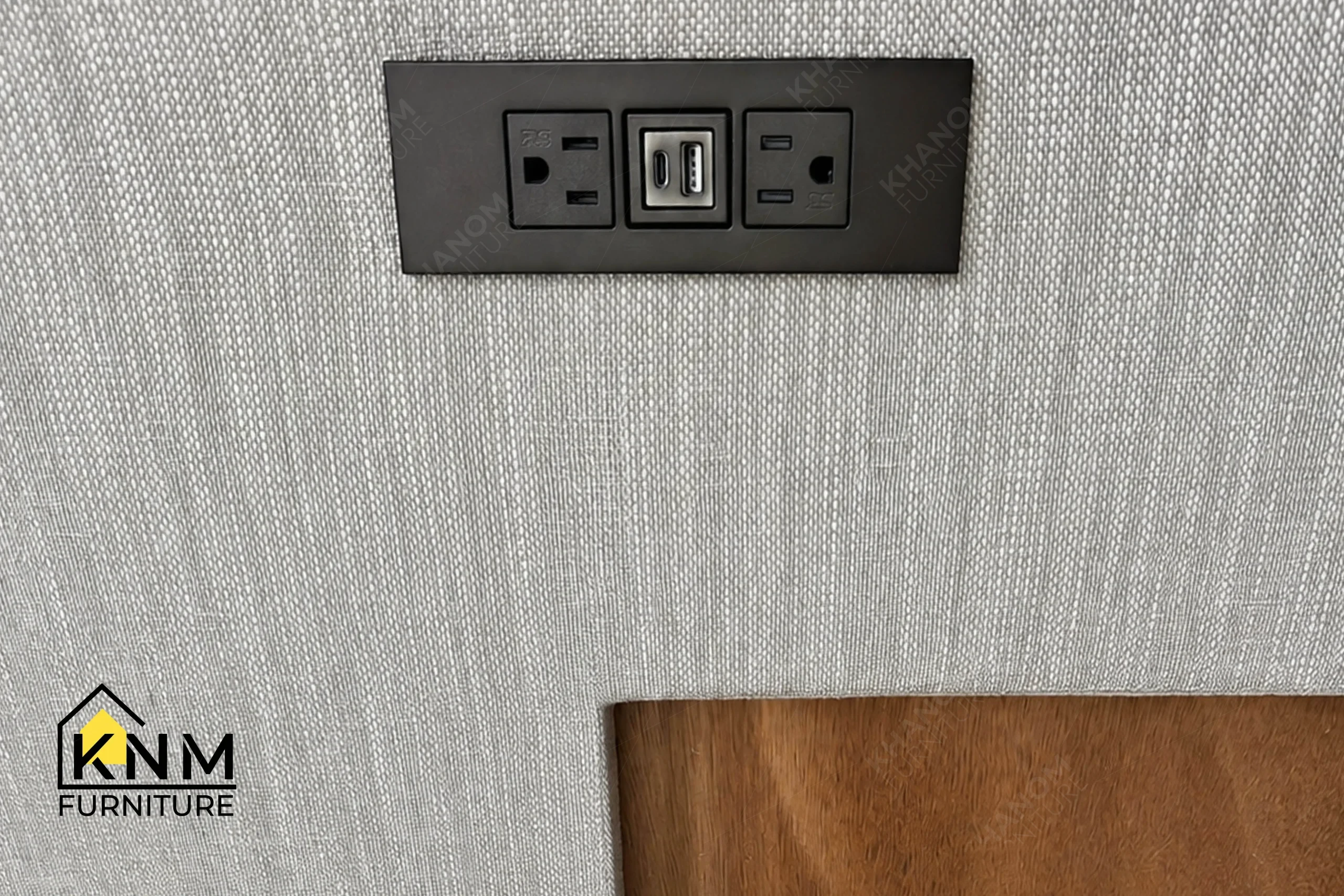 A technical detail of the upholstered hotel bed base and headboard from Khanom Furniture, describing the Bronze Granex metal reveal set into the leather base.