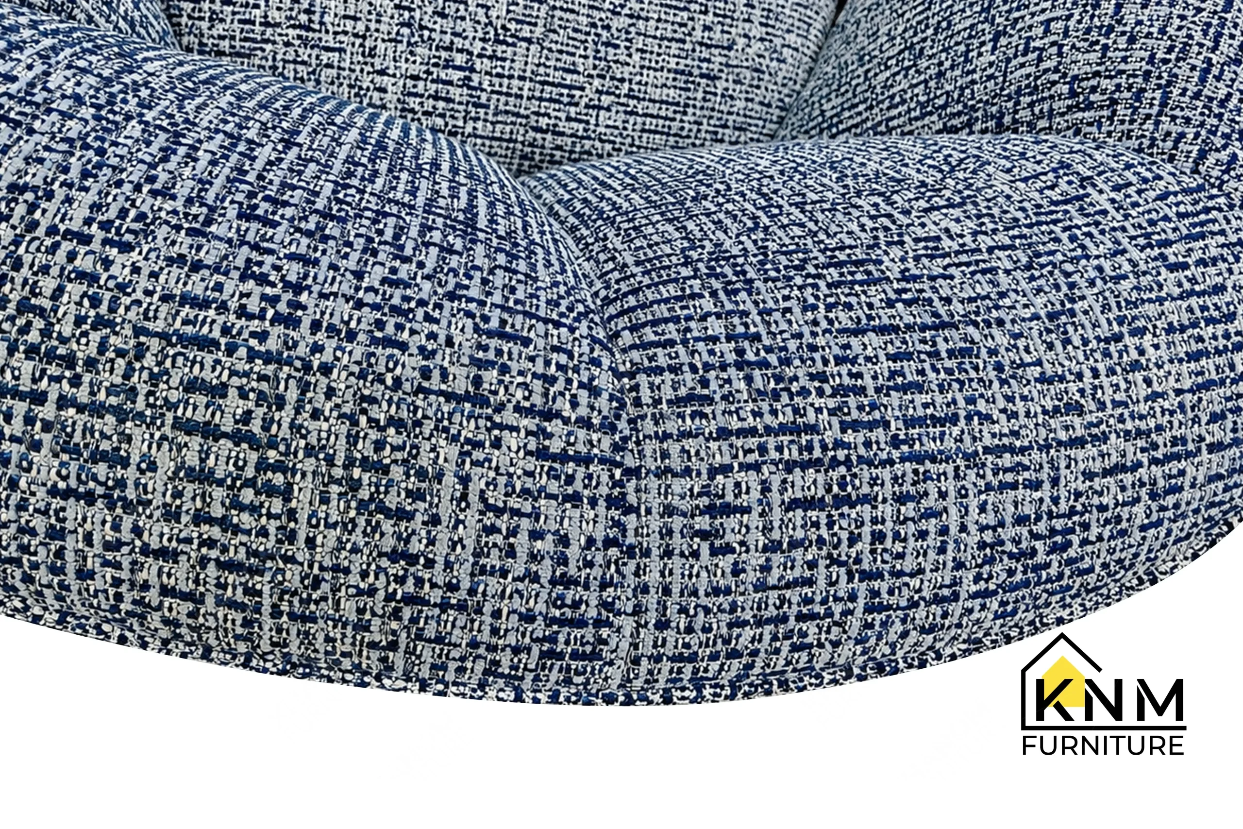 A detailed material zoom of the Fabricut upholstered hardwood lounge chair by Khanom Furniture, showing the texture of the Waterford Nautical fabric.