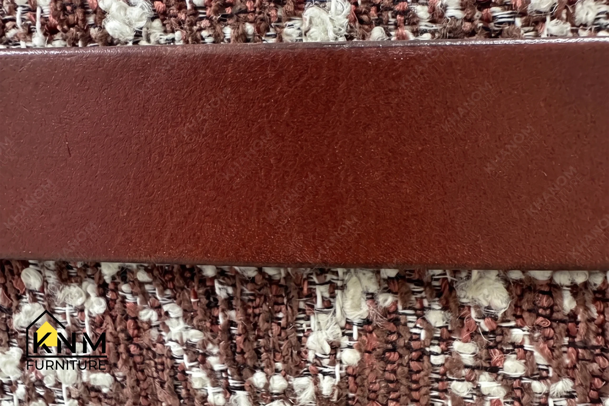 A technical detail of the Multi-COM Maple Full Metal Stretcher Barstool from Khanom Furniture, describing the integrated Keleen Leathers handle.